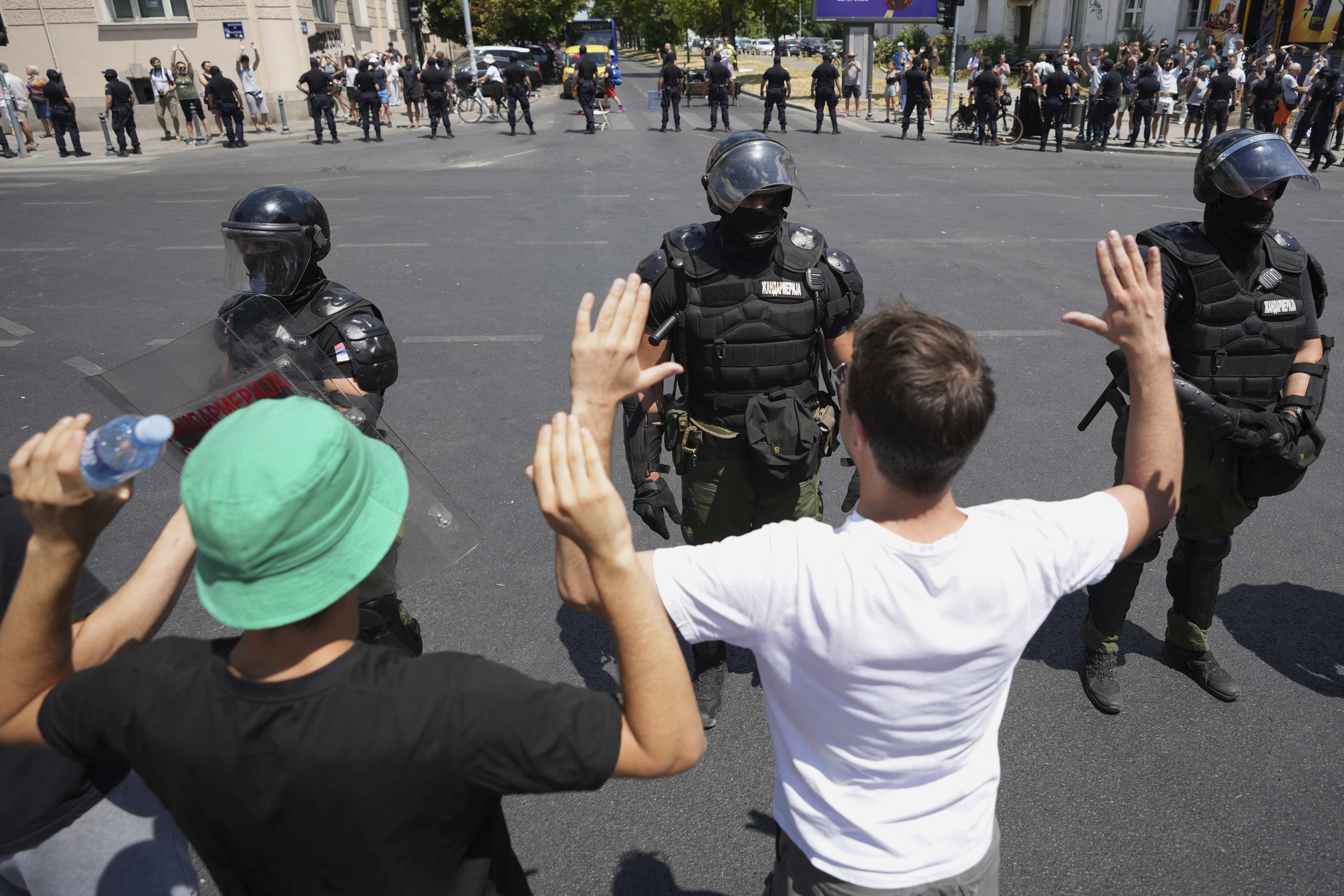 Serbian gendarmerie officers stand in front of anti-government protesters in Belgrade, Serbia, Monday, June 30, 2025. (AP Photo/Darko Vojinovic)