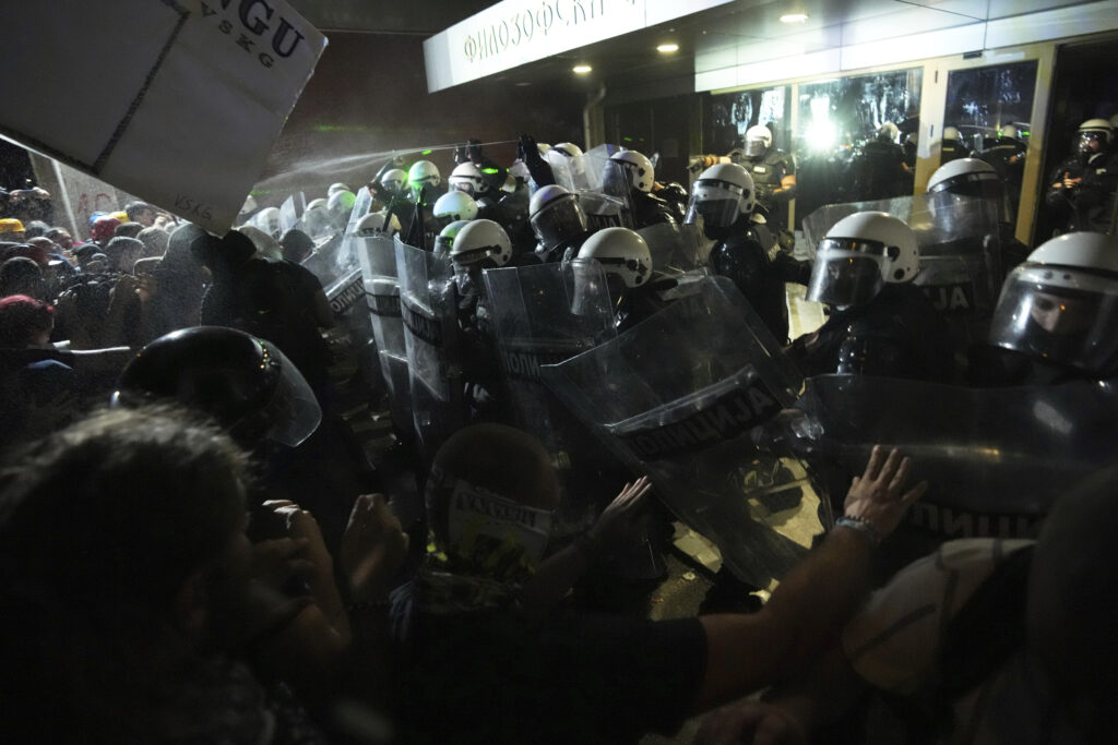 Anti-government protesters clash with riot police during a protest against increasing police brutality in the northern Serbian city of Novi Sad, Friday, Sept. 5, 2025. (AP Photo/Darko Vojinovic)