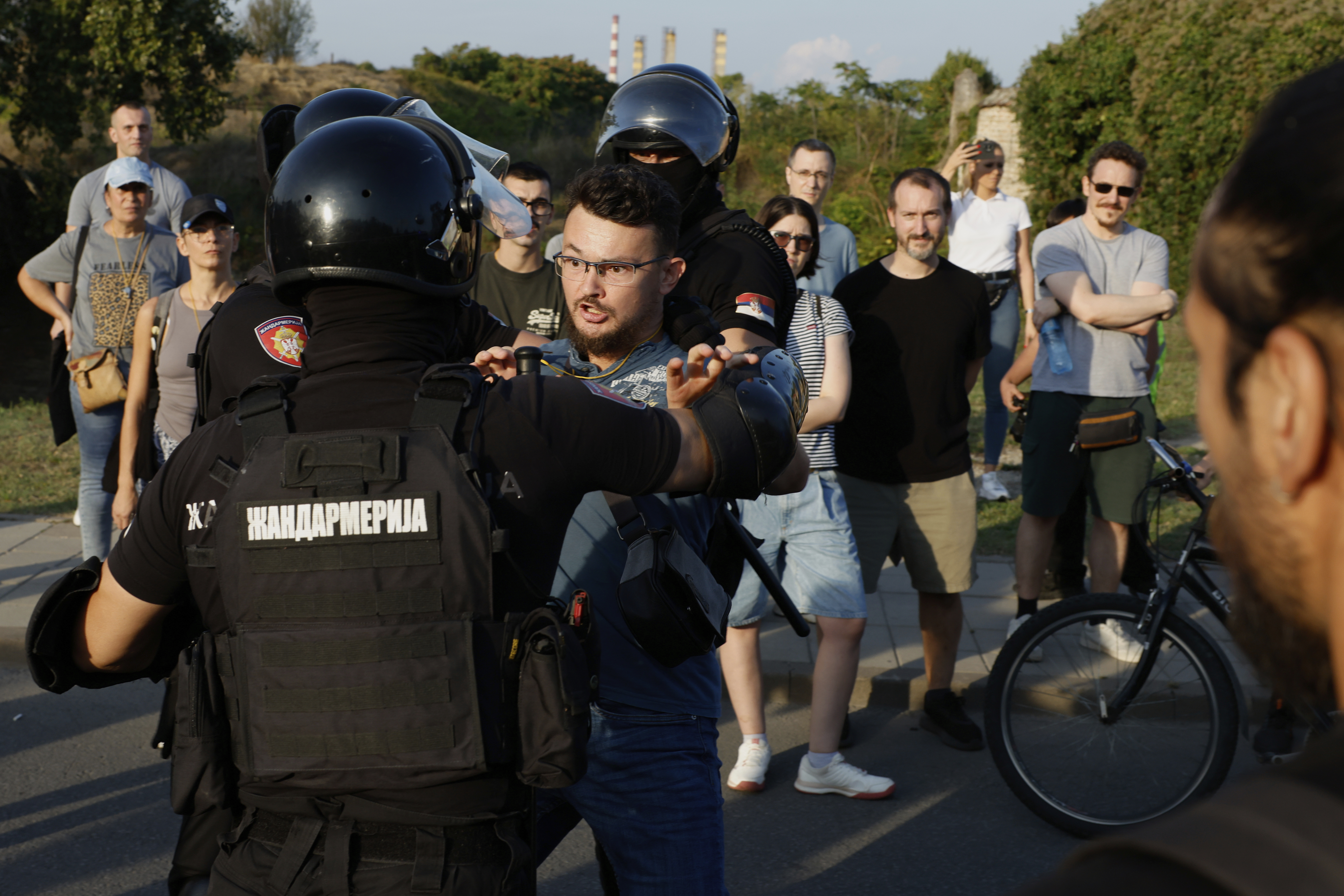 Serbian gendarmerie officers push away an anti-government protester and guard an intersection in Novi Sad, Serbia, Saturday, Sept. 13, 2025. (AP Photo/Marko Drobnjakovic)