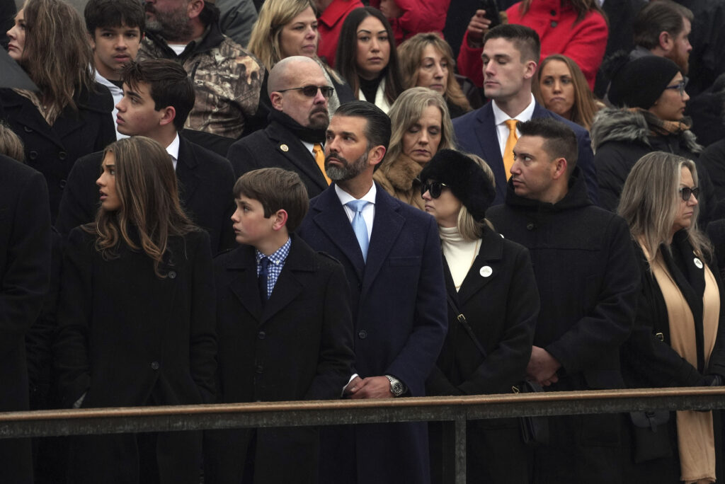 Members of the Trump family, including Donald Trump Jr., arrive before President-elect Donald Trump participates in a wreath laying ceremony at Arlington National Cemetery, Sunday, Jan. 19, 2025, in Arlington, Va. (AP Photo/Evan Vucci)
