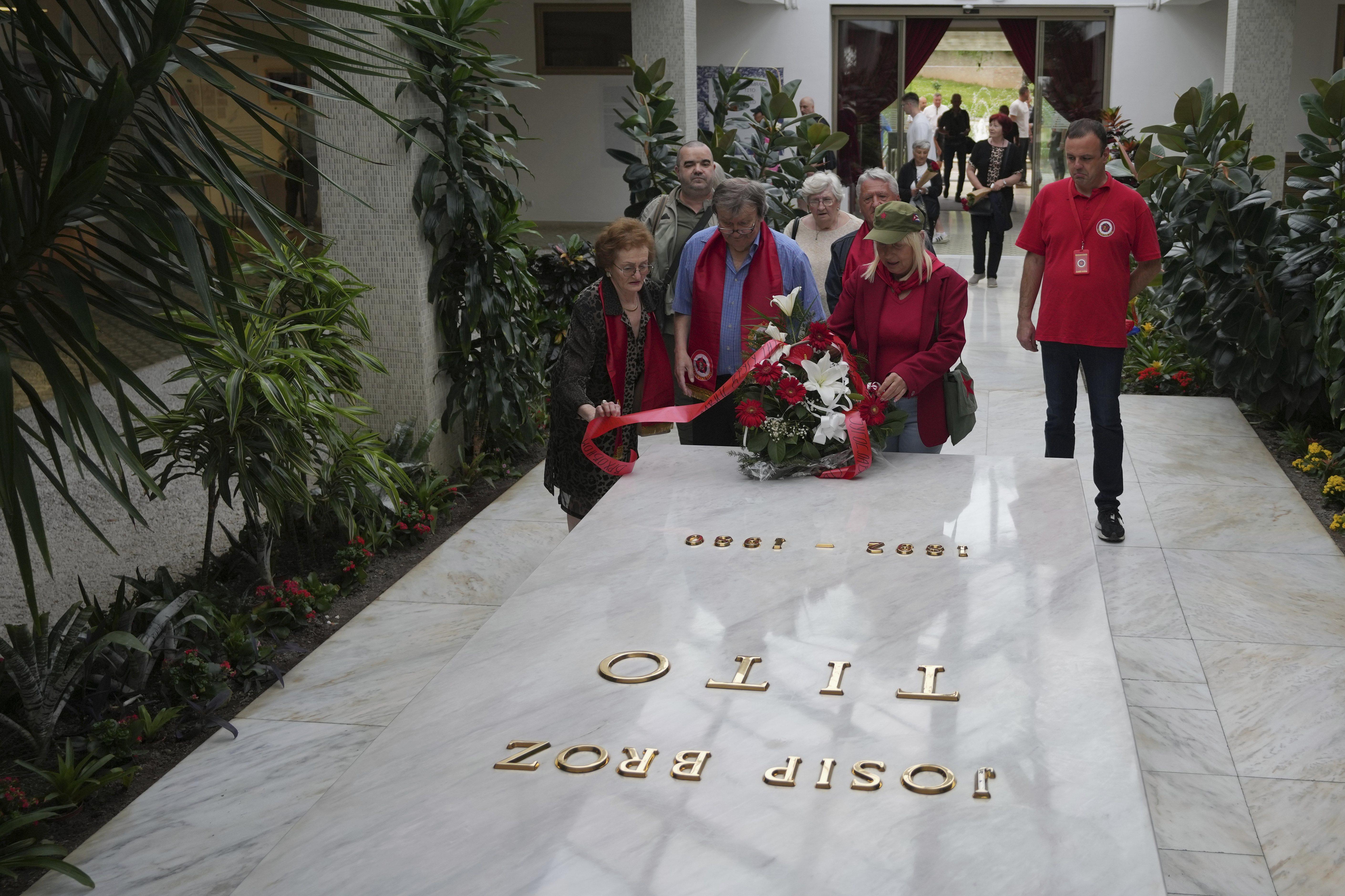 Supporters of the late Yugoslav communist president Josip Broz Tito lay flowers on his tomb during a ceremony marking the 45th anniversary of his death in Belgrade, Serbia, Sunday, May 4, 2025. (AP Photo/Darko Vojinovic)