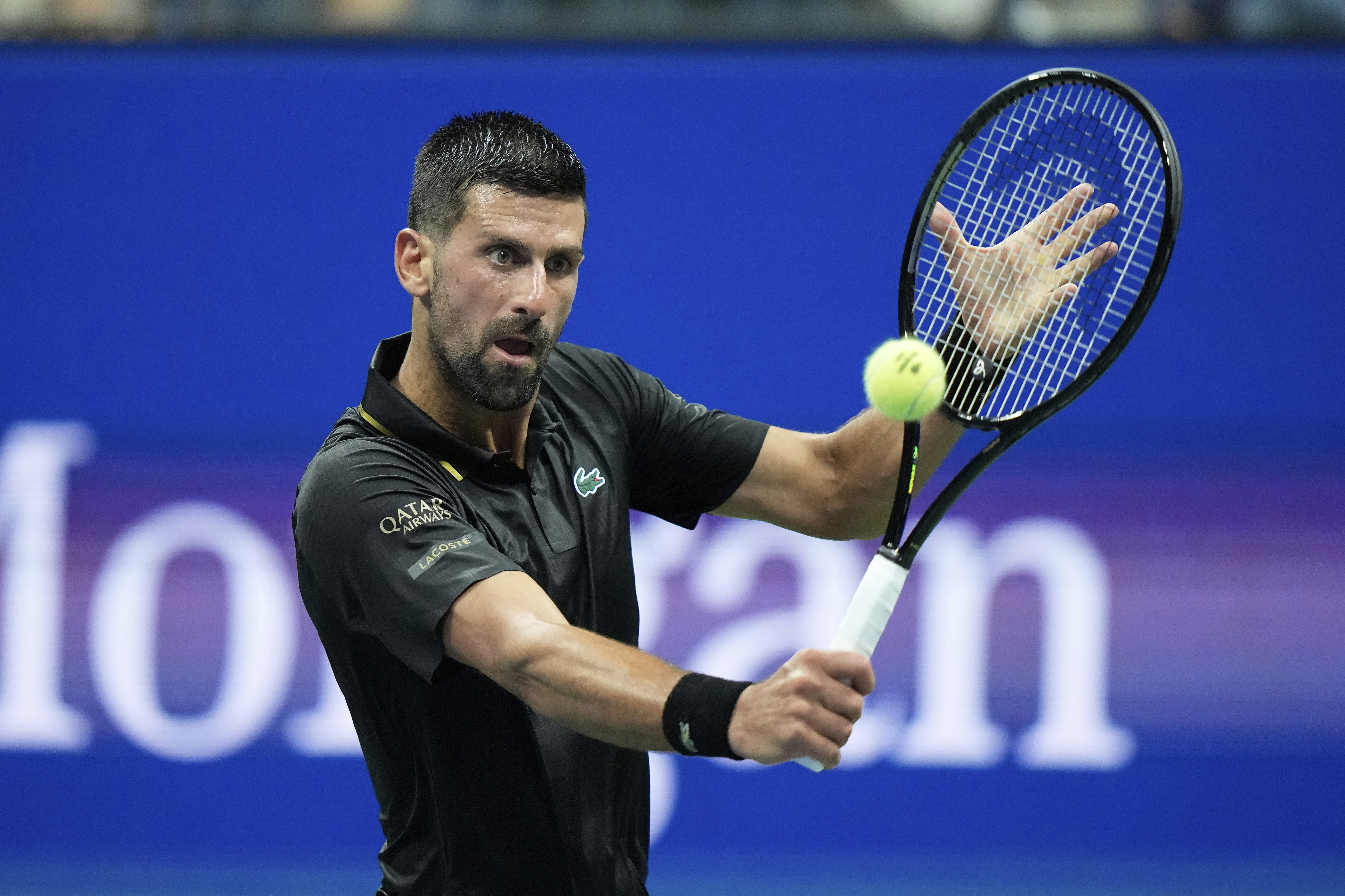 Novak Djokovic, of Serbia, returns a shot to Learner Tien, of the United States, during the first-round of the U.S. Open tennis championships, Sunday, Aug. 24, 2025, in New York. (AP Photo/Frank Franklin II)