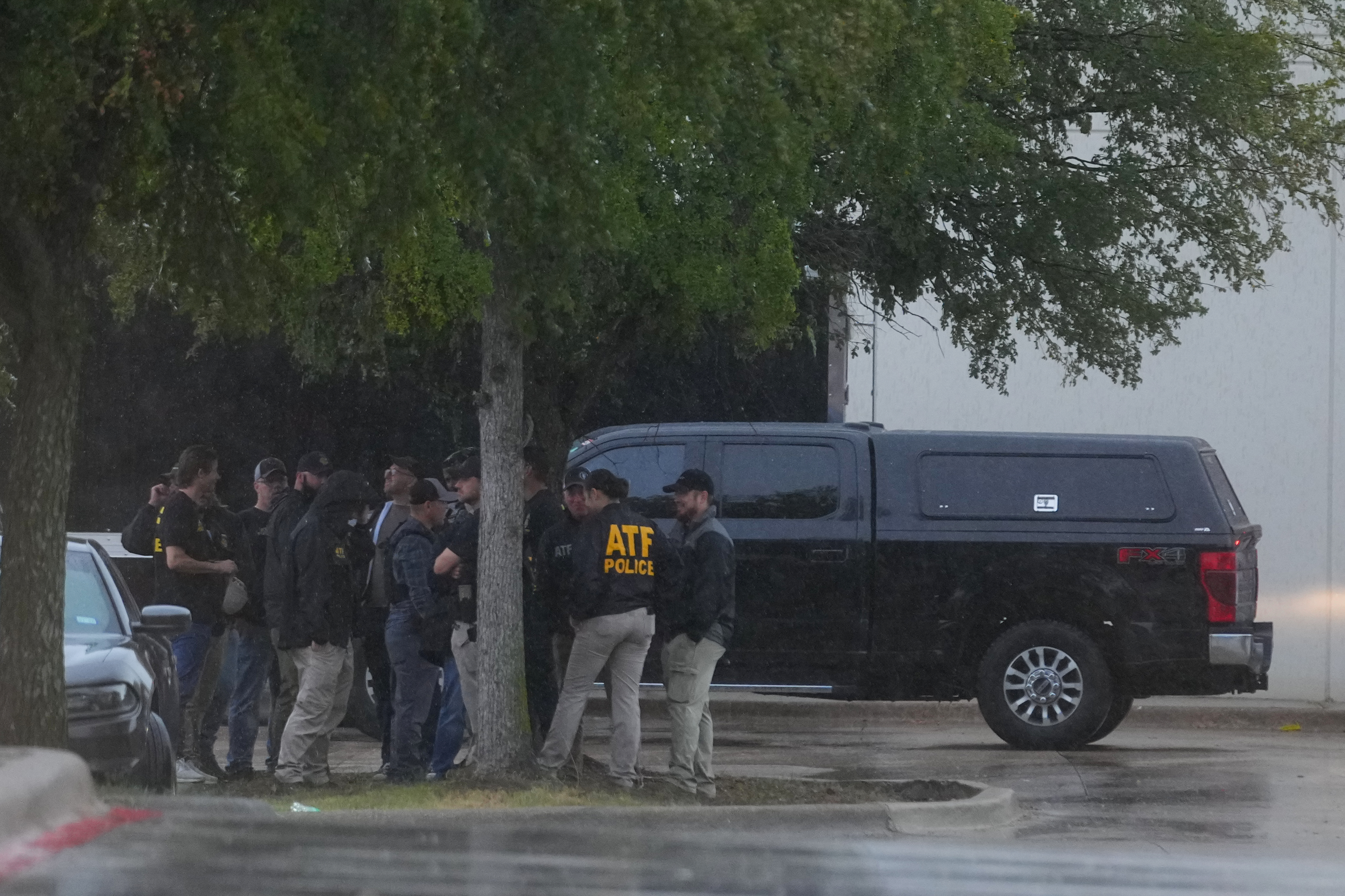 Law enforcement gather at a staging area close to a U.S. Immigration and Customs Enforcement office after a reported shooting, in Dallas on Wednesday, Sept. 24, 2025. (AP Photo/Julio Cortez)