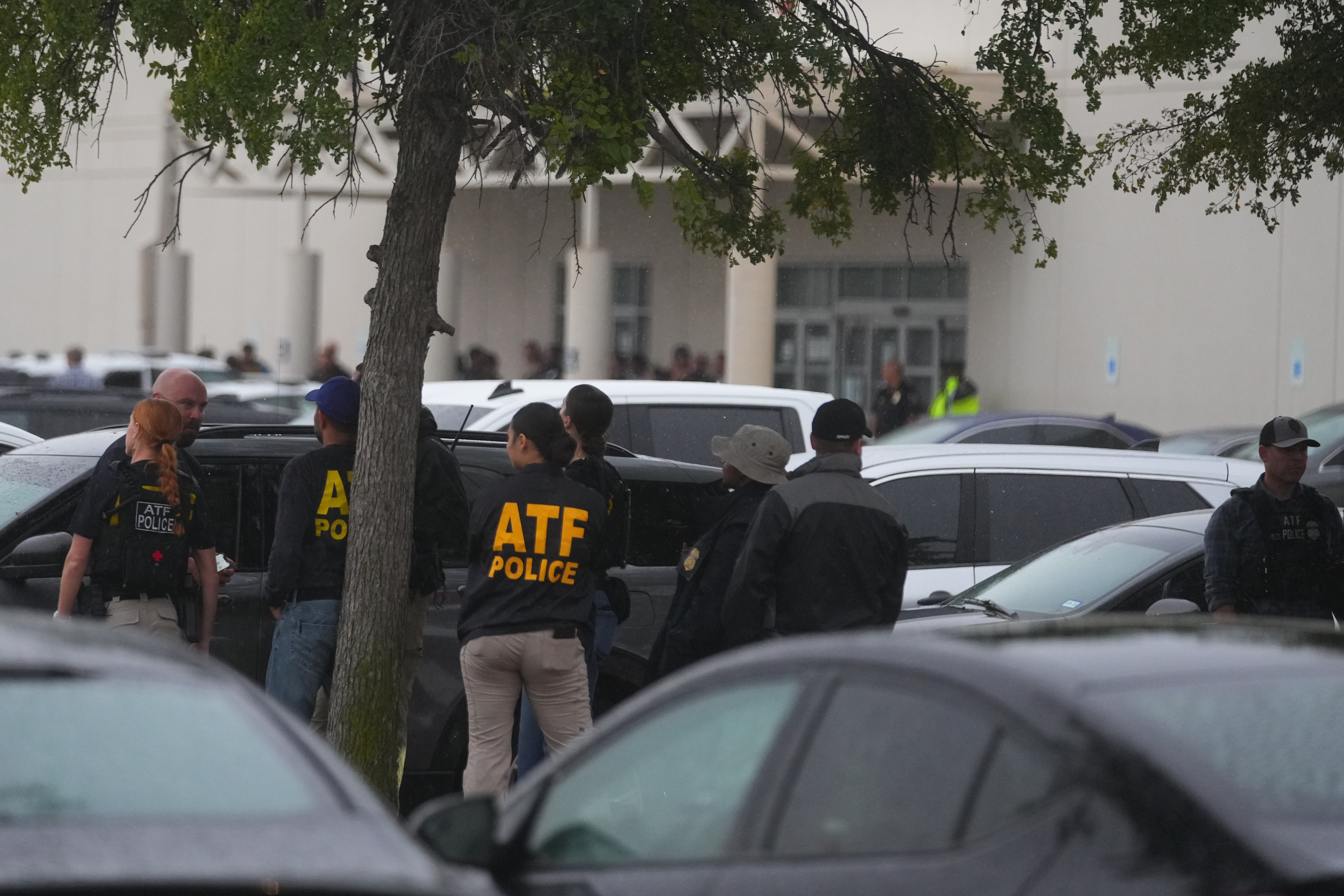 Law enforcement gather at a stating area close to a U.S. Immigration and Customs Enforcement office after a reported shooting, in Dallas on Wednesday, Sept. 24, 2025. (AP Photo/Julio Cortez)