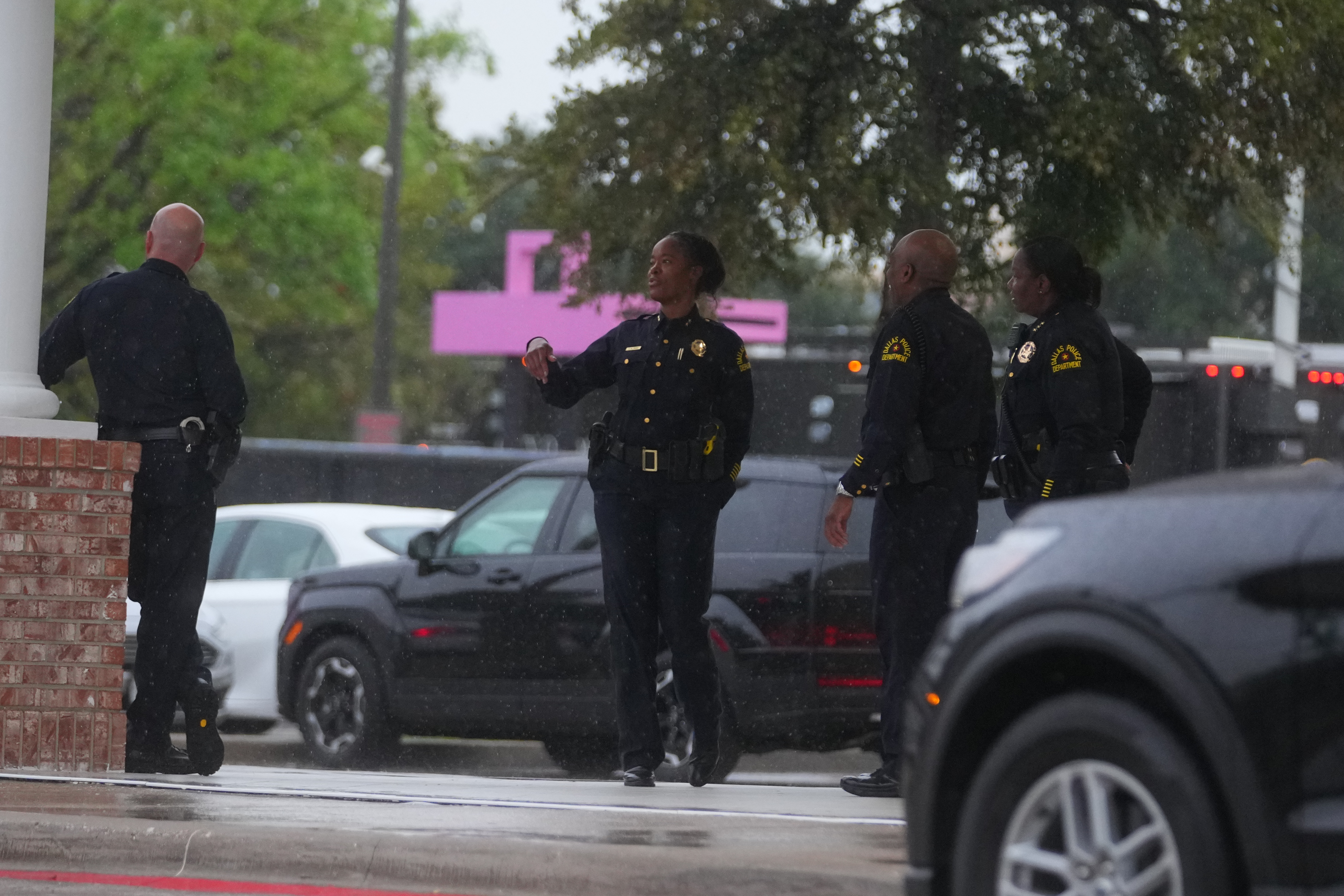 Law enforcement gather at a staging area close to a U.S. Immigration and Customs Enforcement office after a reported shooting, in Dallas on Wednesday, Sept. 24, 2025. (AP Photo/Julio Cortez)
