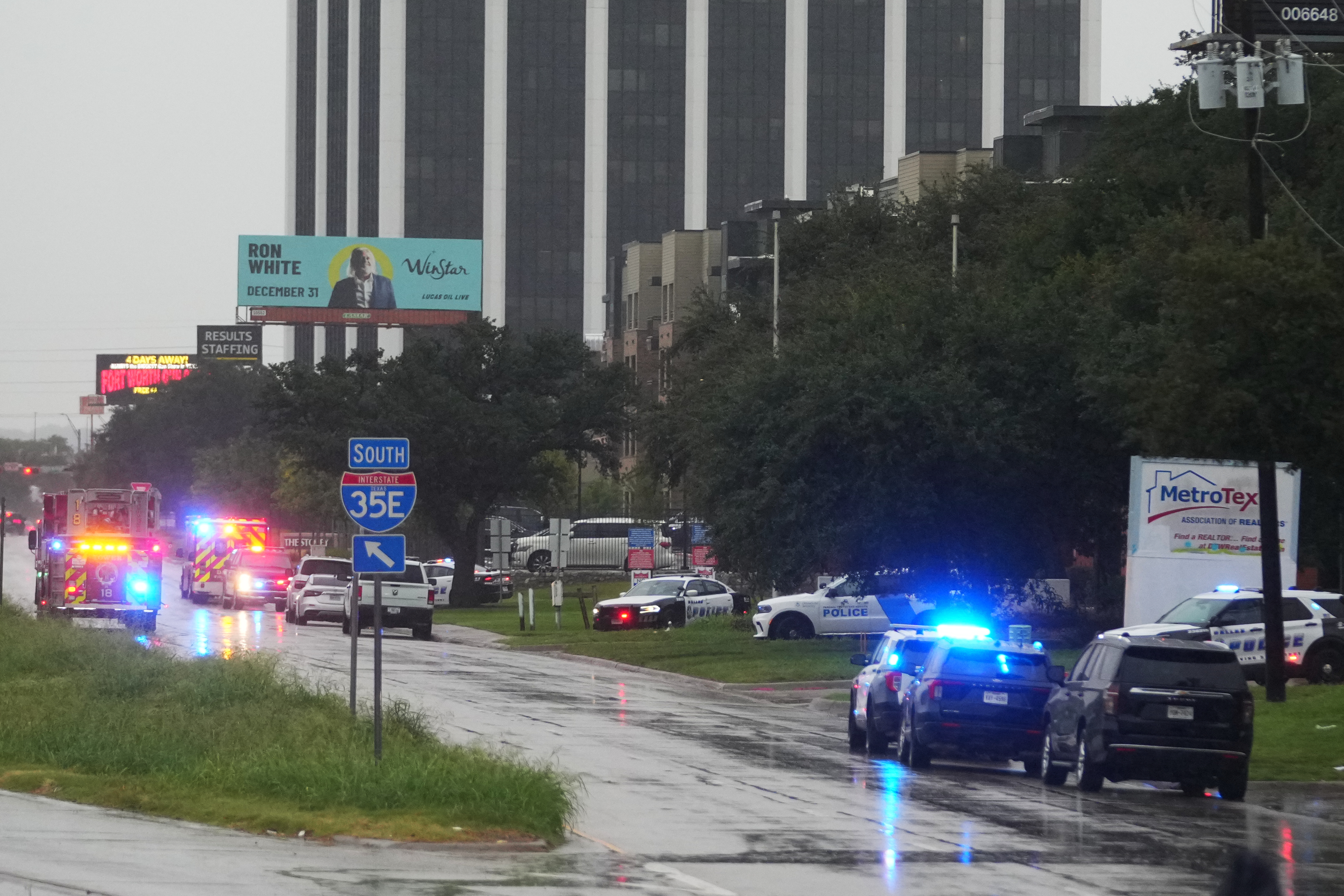 Police block off I-35E close to a U.S. Immigration and Customs Enforcement office after a reported shooting, in Dallas on Wednesday, Sept. 24, 2025. (AP Photo/Julio Cortez)
