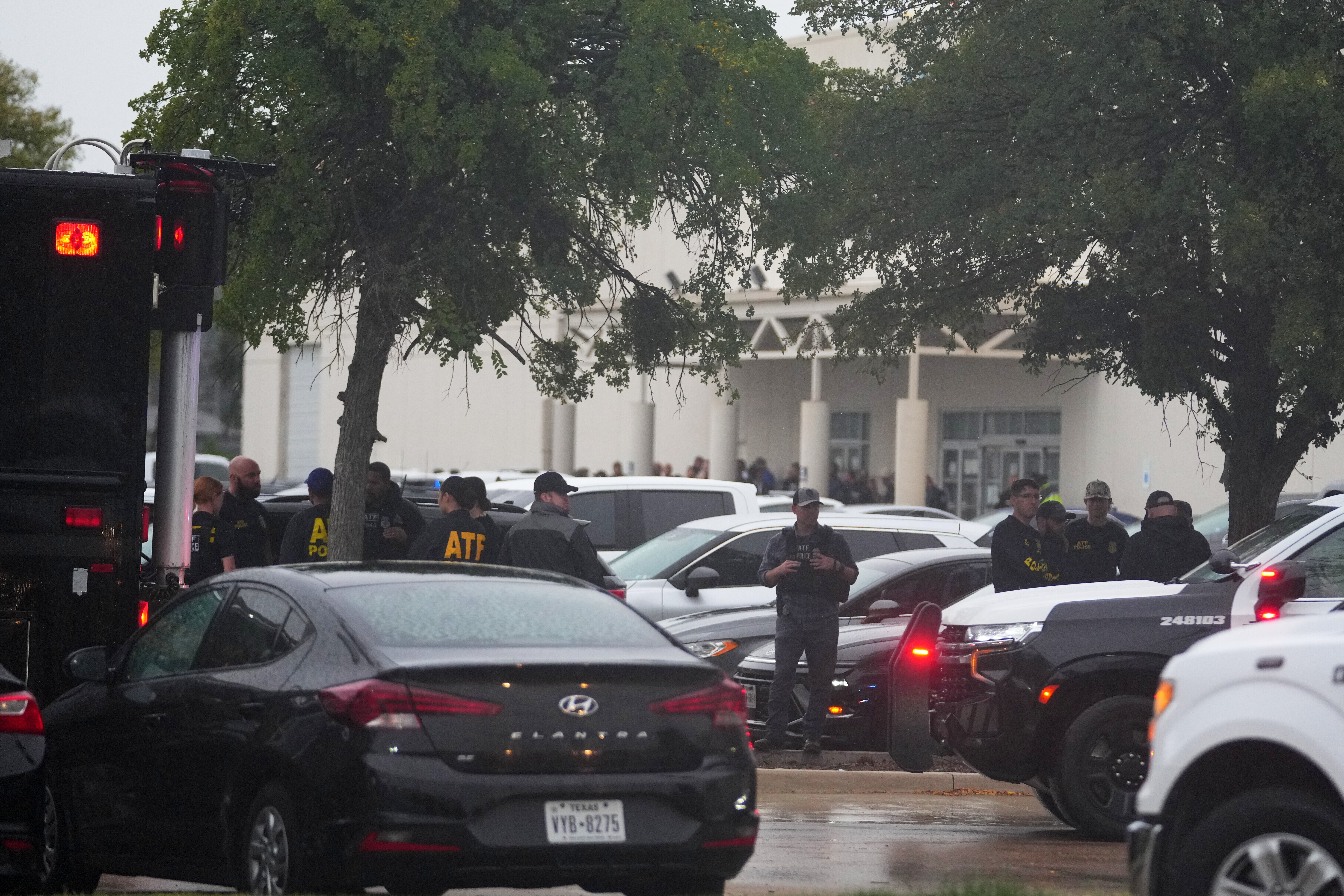 Law enforcement gather at a staging area close to a U.S. Immigration and Customs Enforcement office after a reported shooting, in Dallas on Wednesday, Sept. 24, 2025. (AP Photo/Julio Cortez)
