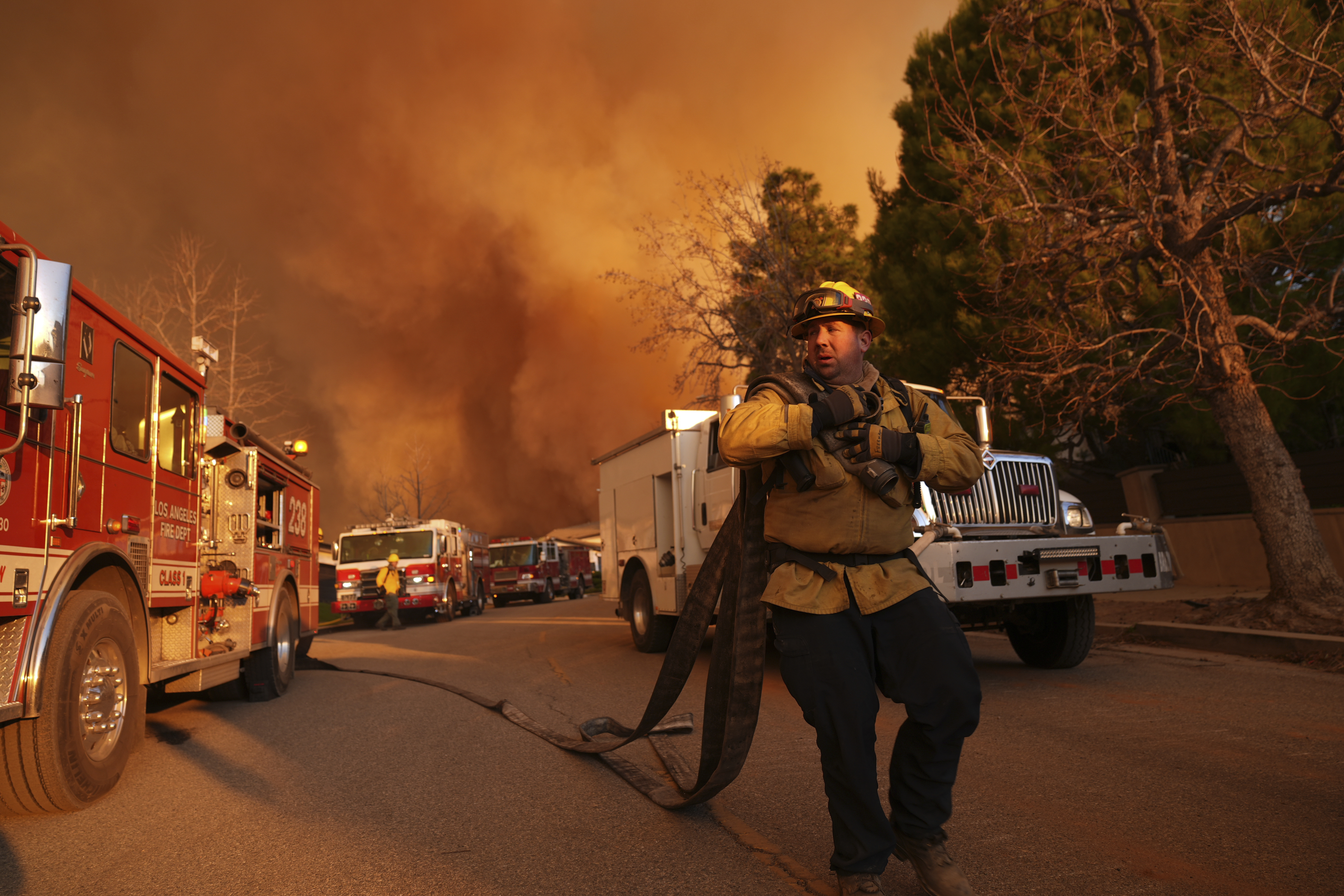 Firefighters make a stand in front of the Palisades Fire in Mandeville Canyon Saturday, Jan. 11, 2025, in Los Angeles. (AP Photo/Jae C. Hong)