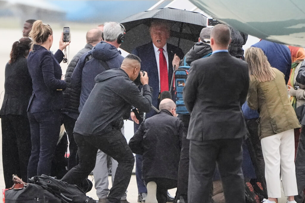 President Donald Trump speaks with reporters before boarding Air Force One, Sunday, Oct. 12, 2025, at Joint Base Andrews, Md., as he heads to the Middle East. (AP Photo/Mark Schiefelbein)