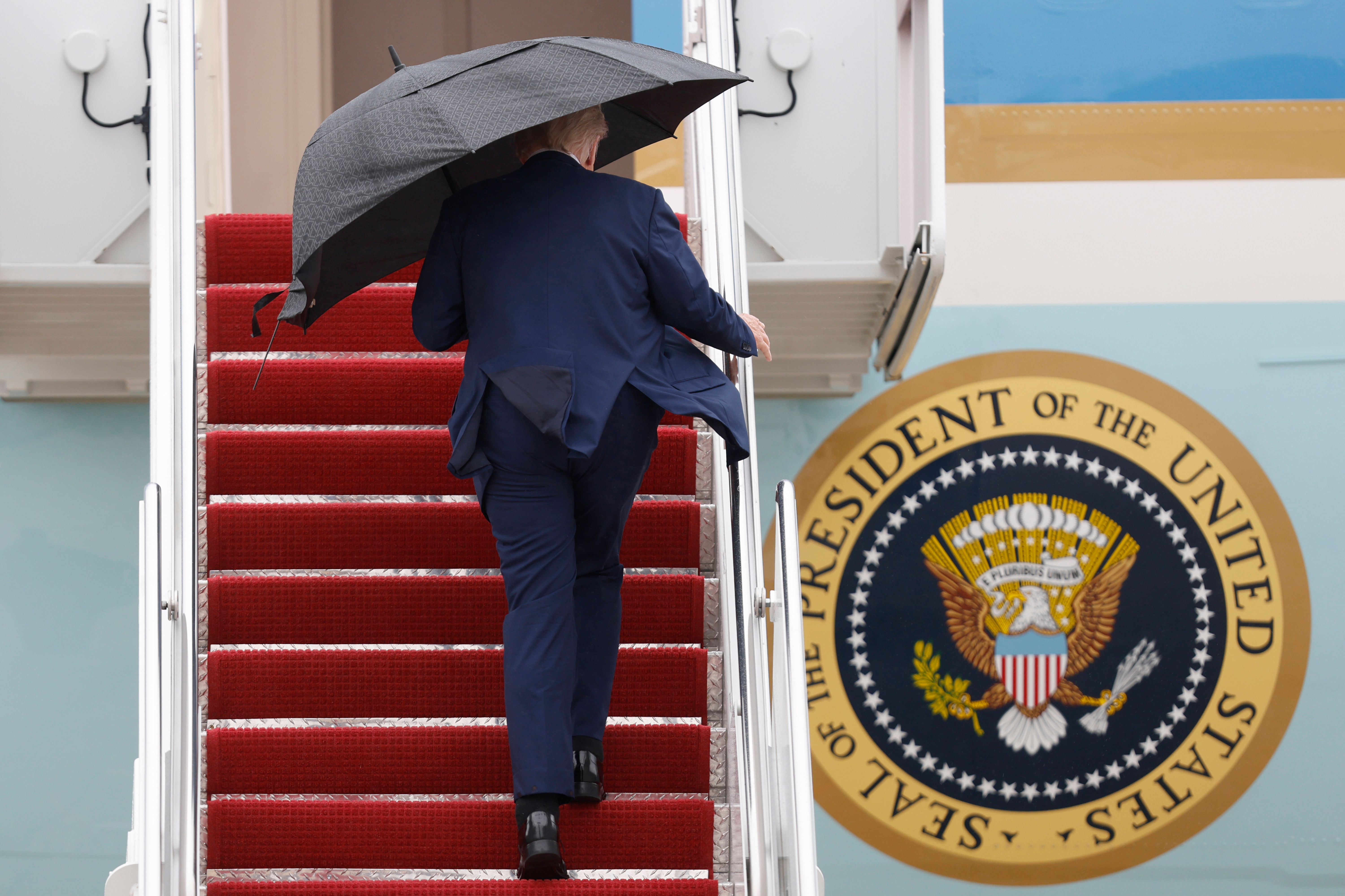 President Donald Trump walks up the stairs of Air Force One as he boards upon his arrival at Joint Base Andrews, Md., Sunday, Oct. 12, 2025. (AP Photo/Luis M. Alvarez)