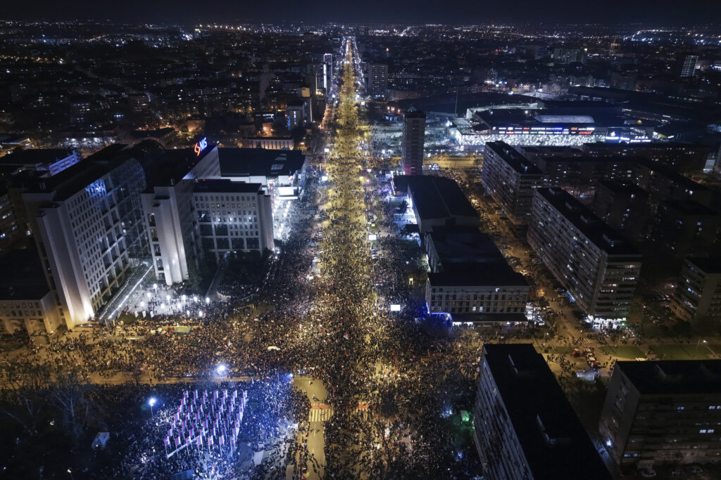 An aerial view of people blocking the Bridge of Freedom during a protest over the collapse of a concrete canopy that killed 15 people more than two months ago, in Novi Sad, Serbia, Saturday, Feb. 1, 2025. (AP Photo/Armin Durgut)