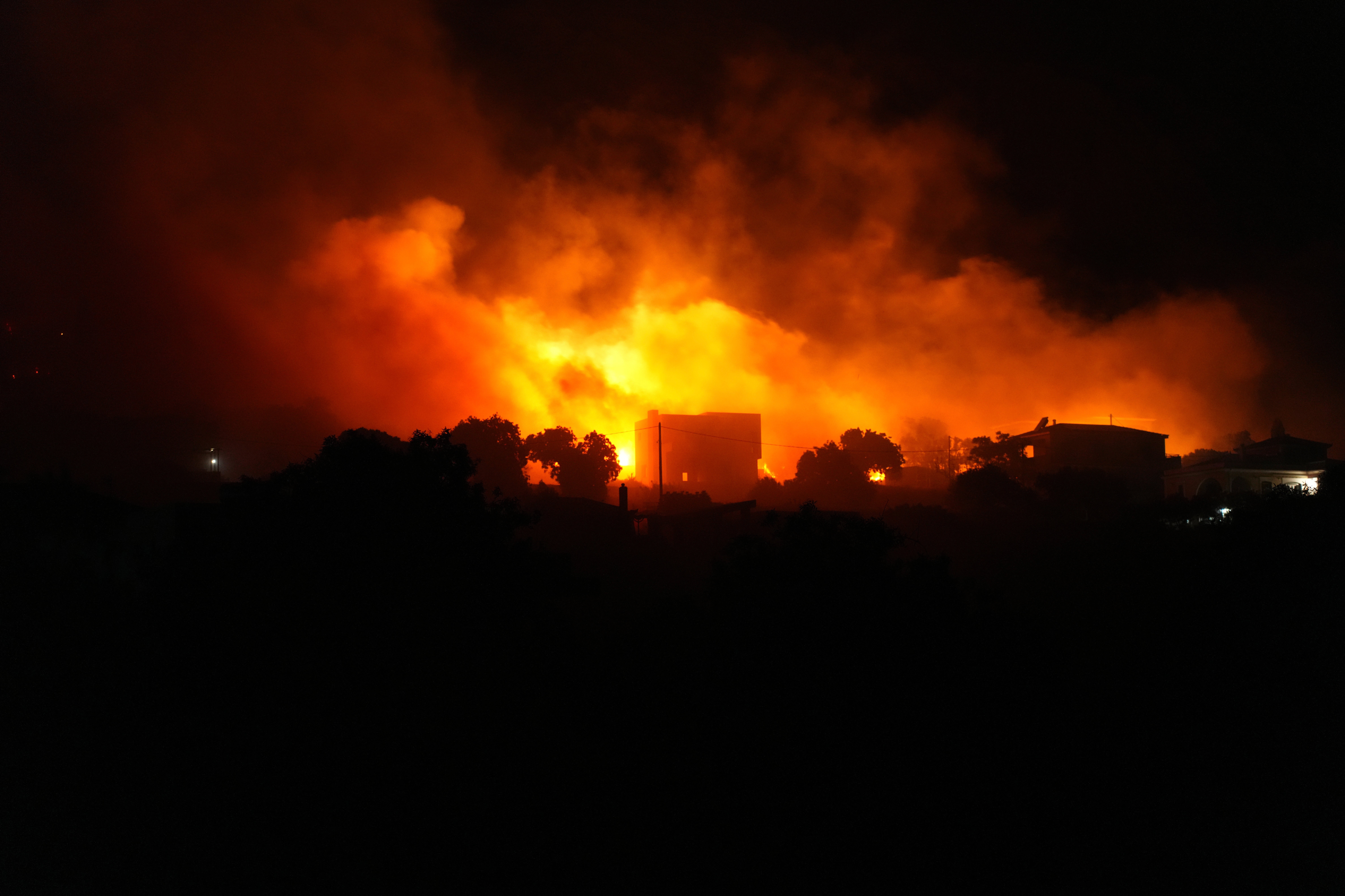A large wildfire burns in Karyes village, on the eastern Aegean island of Chios, Greece, Sunday, June 22, 2025. (Pantelis Fykaris/Politischios.gr via AP)