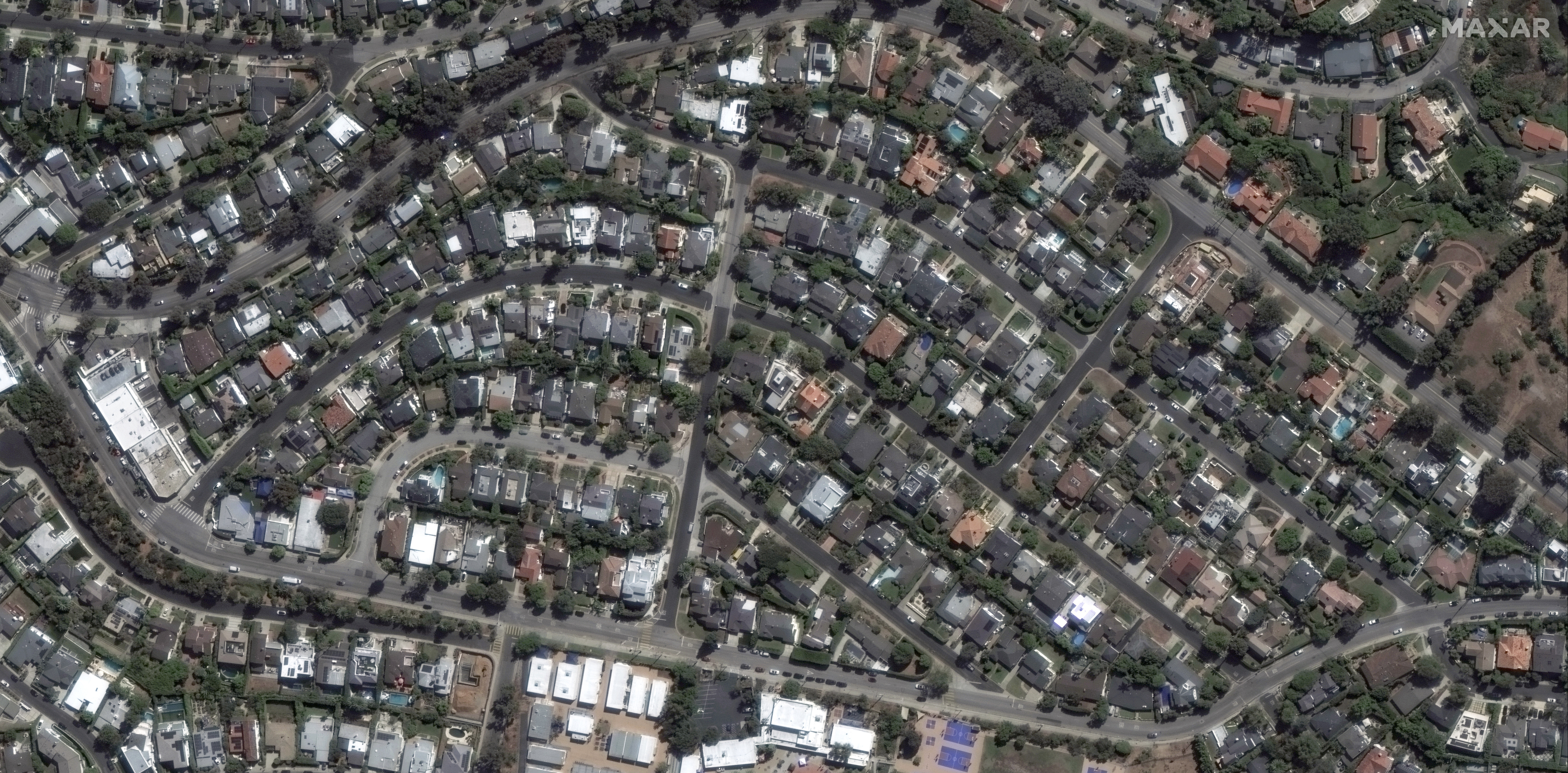 This satellite image provided by Maxar Technologies shows homes before the Palisades Fire in the Pacific Palisades neighborhood of Los Angeles, Oct. 20, 2024. (Maxar Technologies via AP)