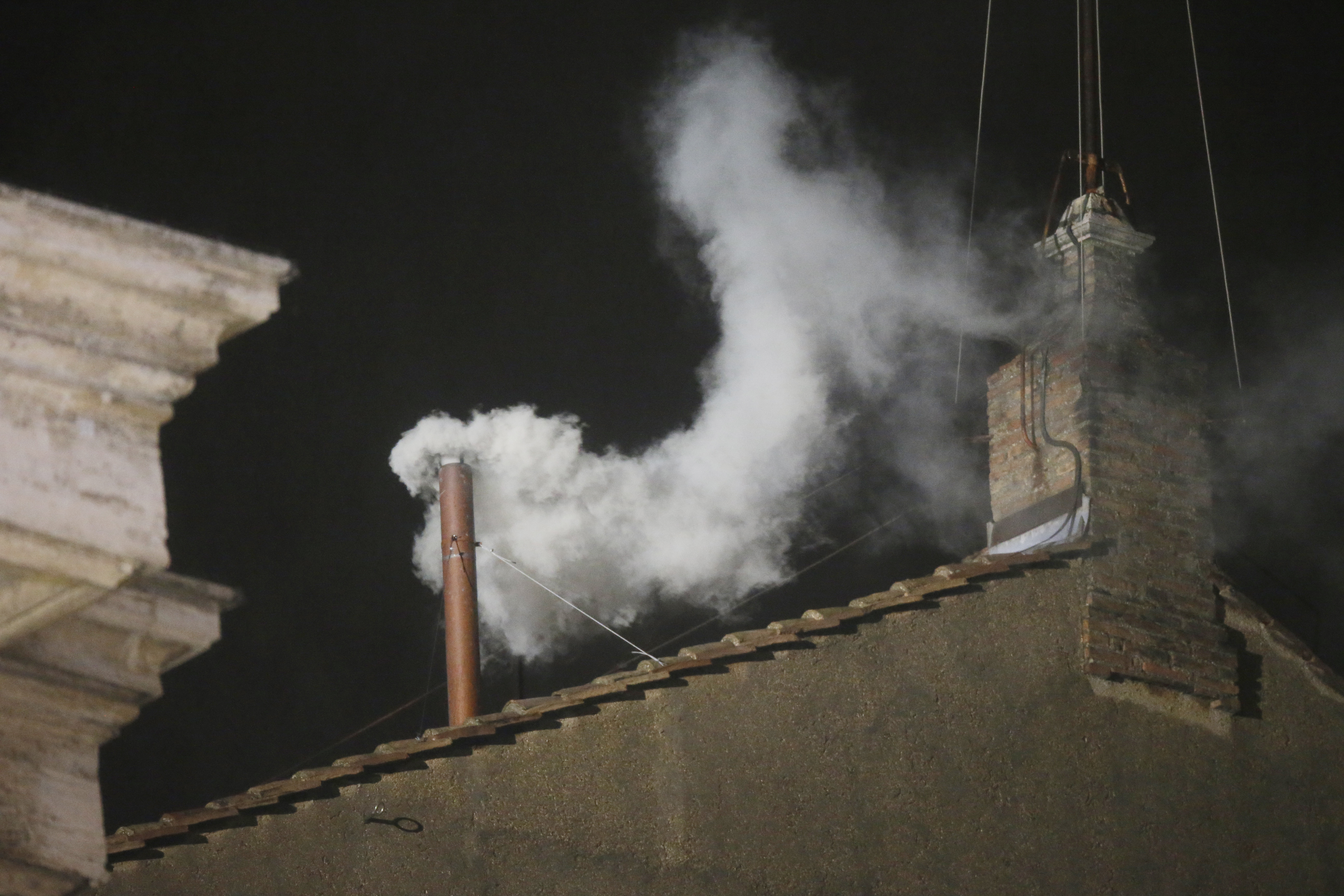FILE - White smoke is seen billowing out from the chimney of the Sistine Chapel and announcing that a new pope has been elected on Wednesday, March 13, 2013. (AP Photo/Gregorio Borgia, File)
