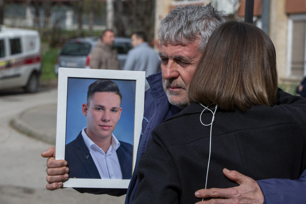 Tomco Stojanov who said his son Andrej died in the fire holds his portrait outside a hospital in the town of Kocani, North Macedonia, Monday, March 17, 2025, following a massive fire in the nightclub early Sunday. (AP Photo/Visar Kryeziu)