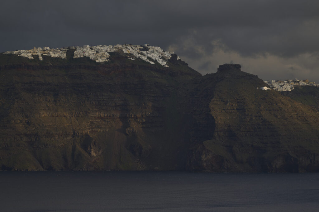 The main town of Fira is seen from across a bay on the earthquake-struck island of Santorini, Greece, Tuesday, Feb. 4, 2025. (AP Photo/Petros Giannakouris)