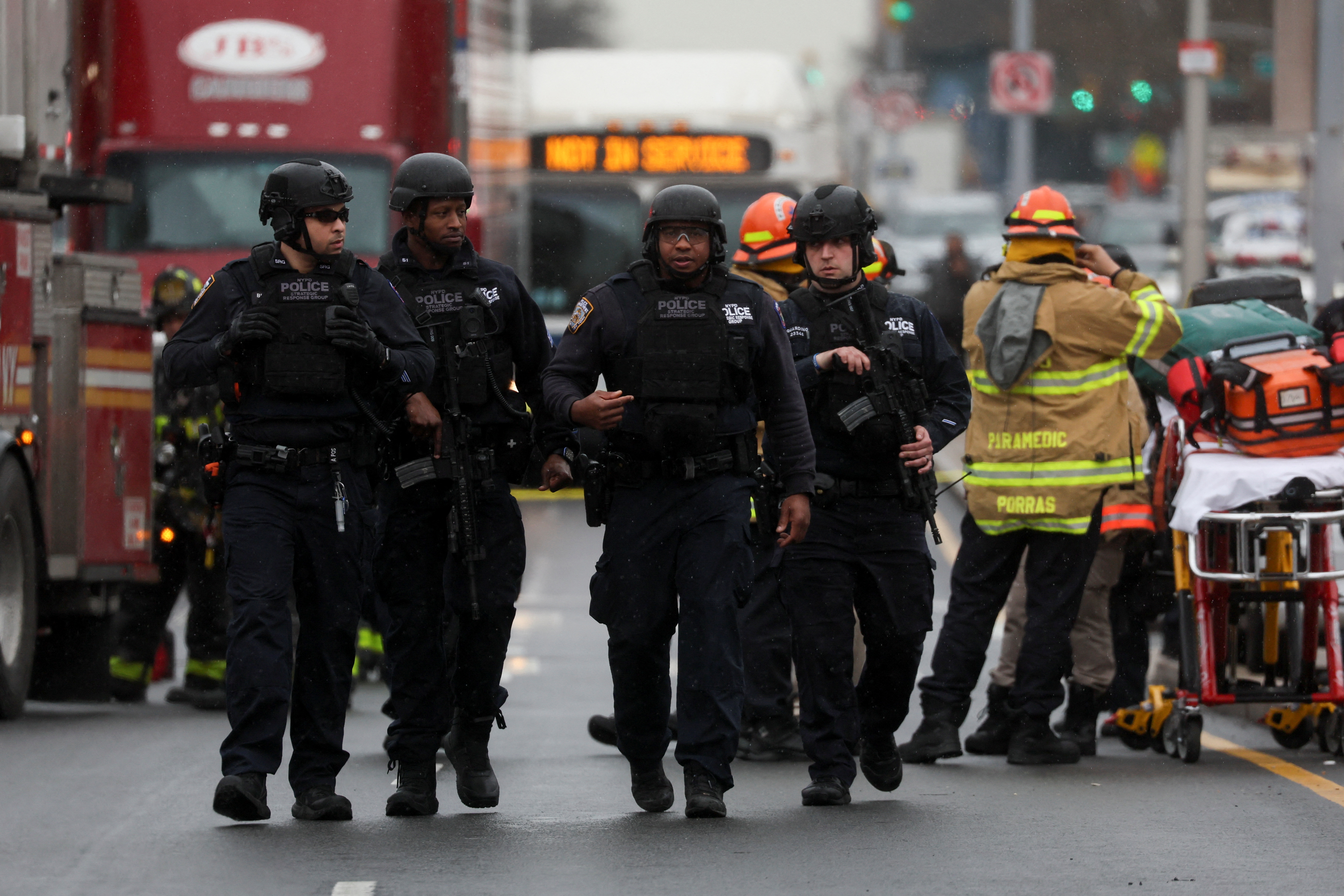 Police officers walk near the scene of a shooting at a subway station in the Brooklyn borough of New York City, New York, U.S., April 12, 2022. REUTERS/Brendan McDermid