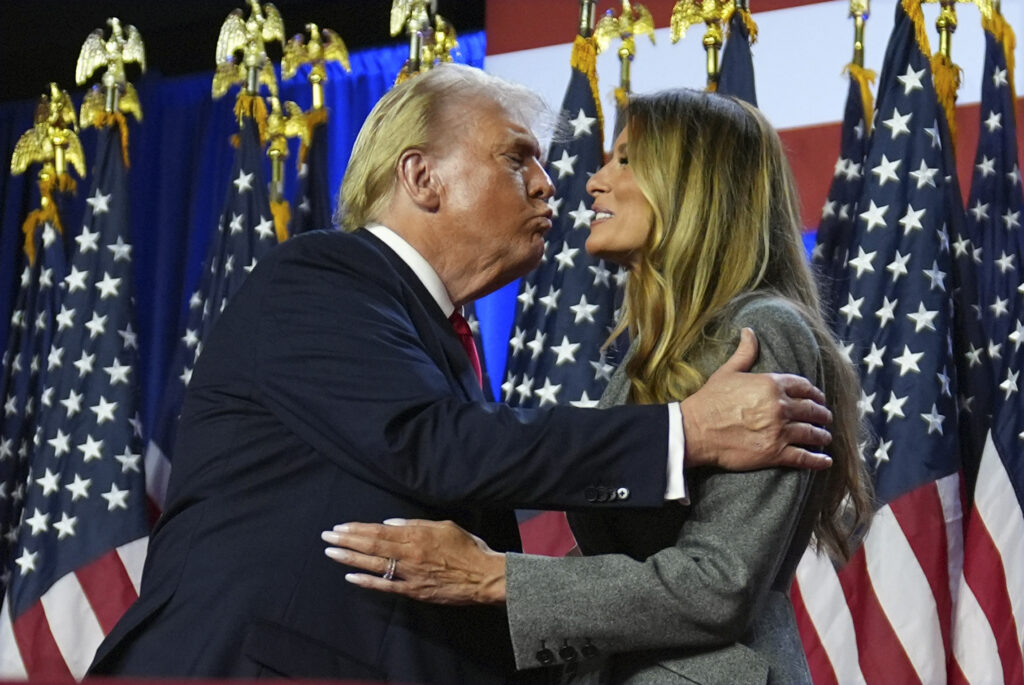 Republican presidential nominee former President Donald Trump kisses former first lady Melania Trump at an election night watch party at the Palm Beach Convention Center, Wednesday, Nov. 6, 2024, in West Palm Beach, Fla. (AP Photo/Evan Vucci)