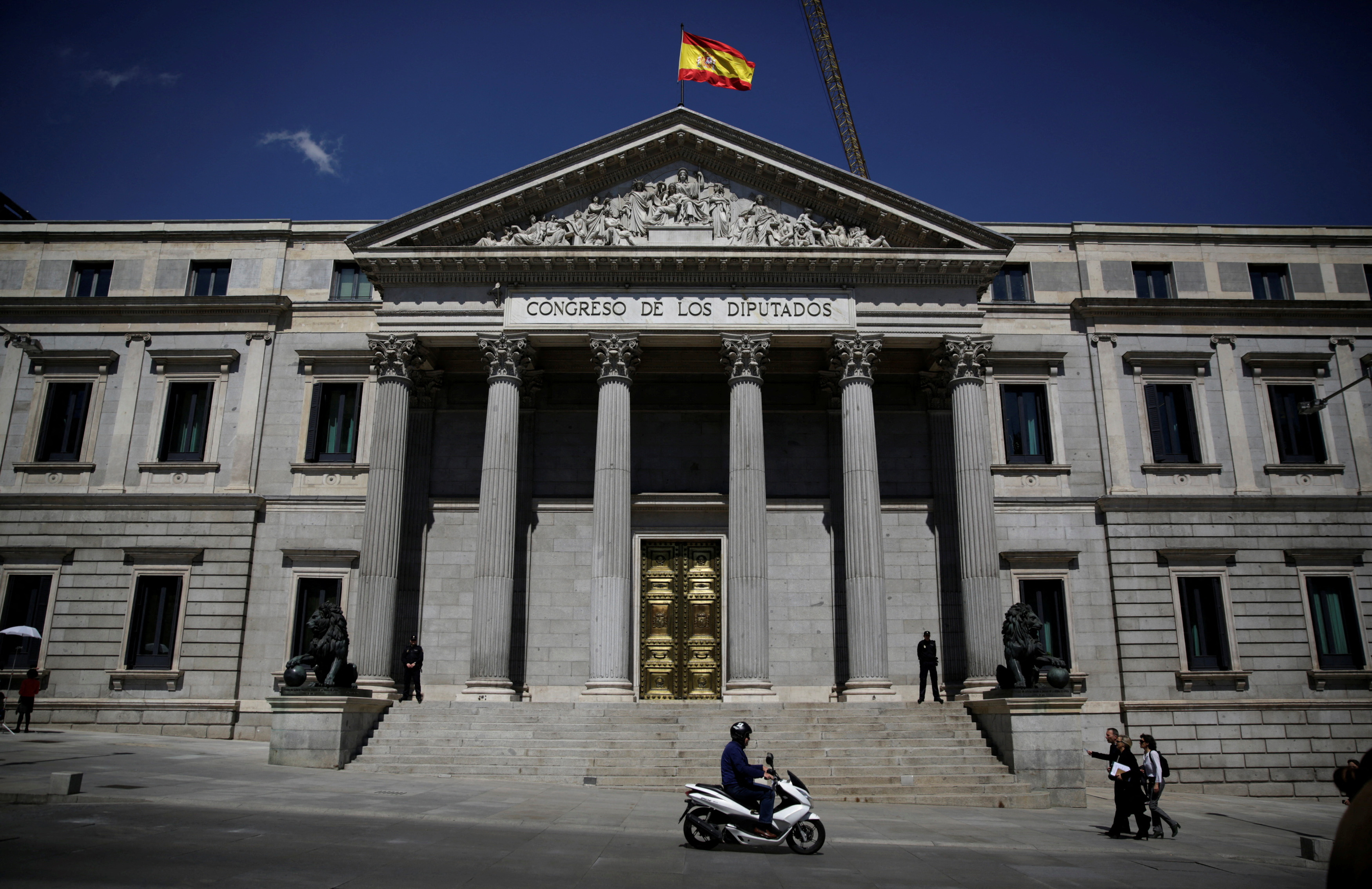 FILE PHOTO: A Spanish flag waves over the Spanish parliament in Madrid
