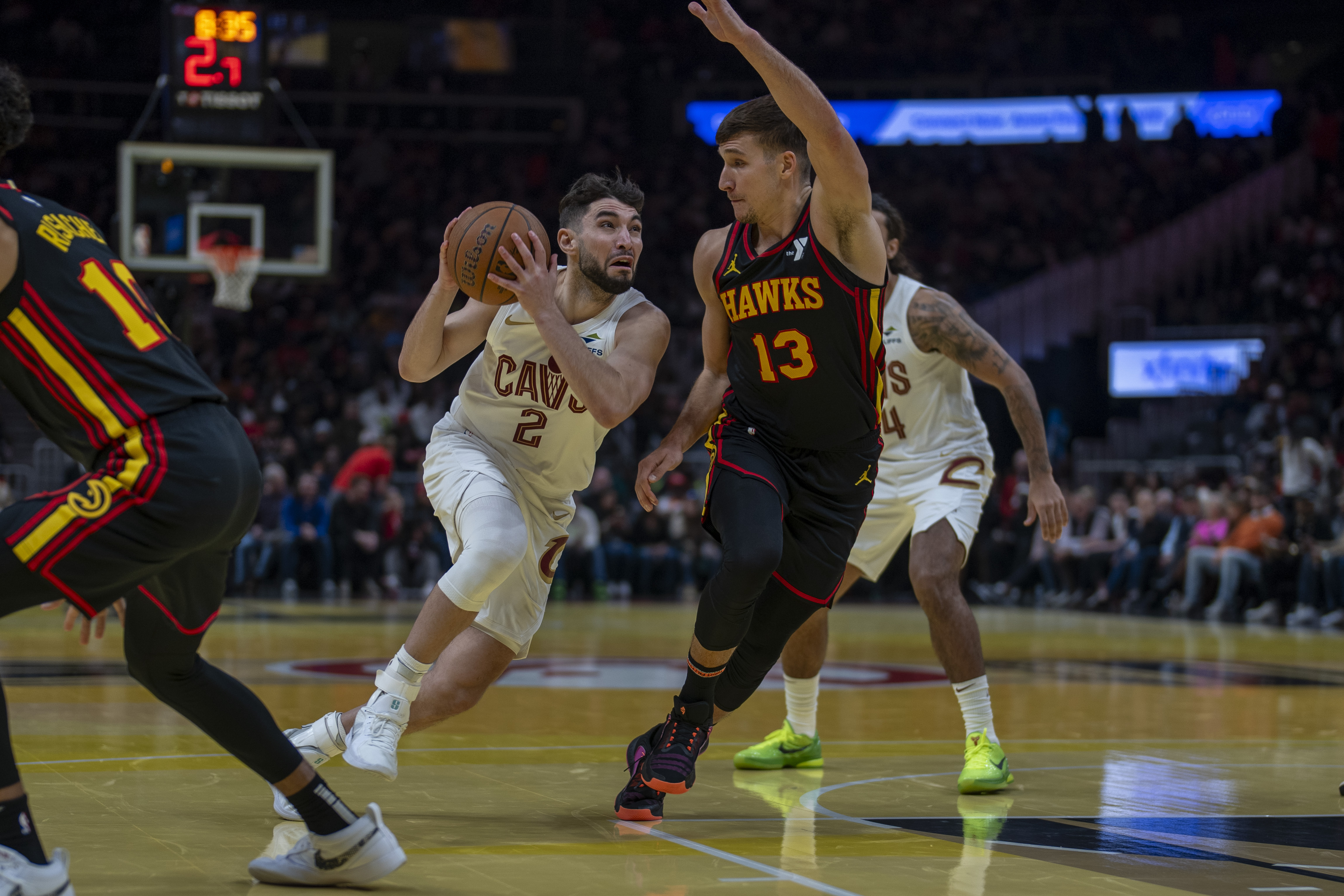 Cleveland Cavaliers guard Ty Jerome (2) attempts to pass the ball against Atlanta Hawks guard Bogdan Bogdanovic (13) during the first half of an Emirates NBA Cup basketball game Friday, Nov. 29, 2024, in Atlanta. (AP Photo/Erik Rank)
