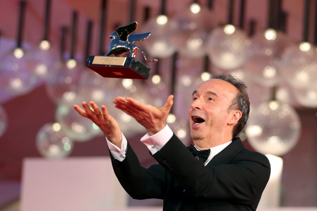 The 78th Venice Film Festival - Opening Ceremony - Venice, Italy, September 1, 2021 - Actor Roberto Benigni poses with a Golden Lion award for lifetime achievement on the red carpet. REUTERS/Yara Nardi     TPX IMAGES OF THE DAY