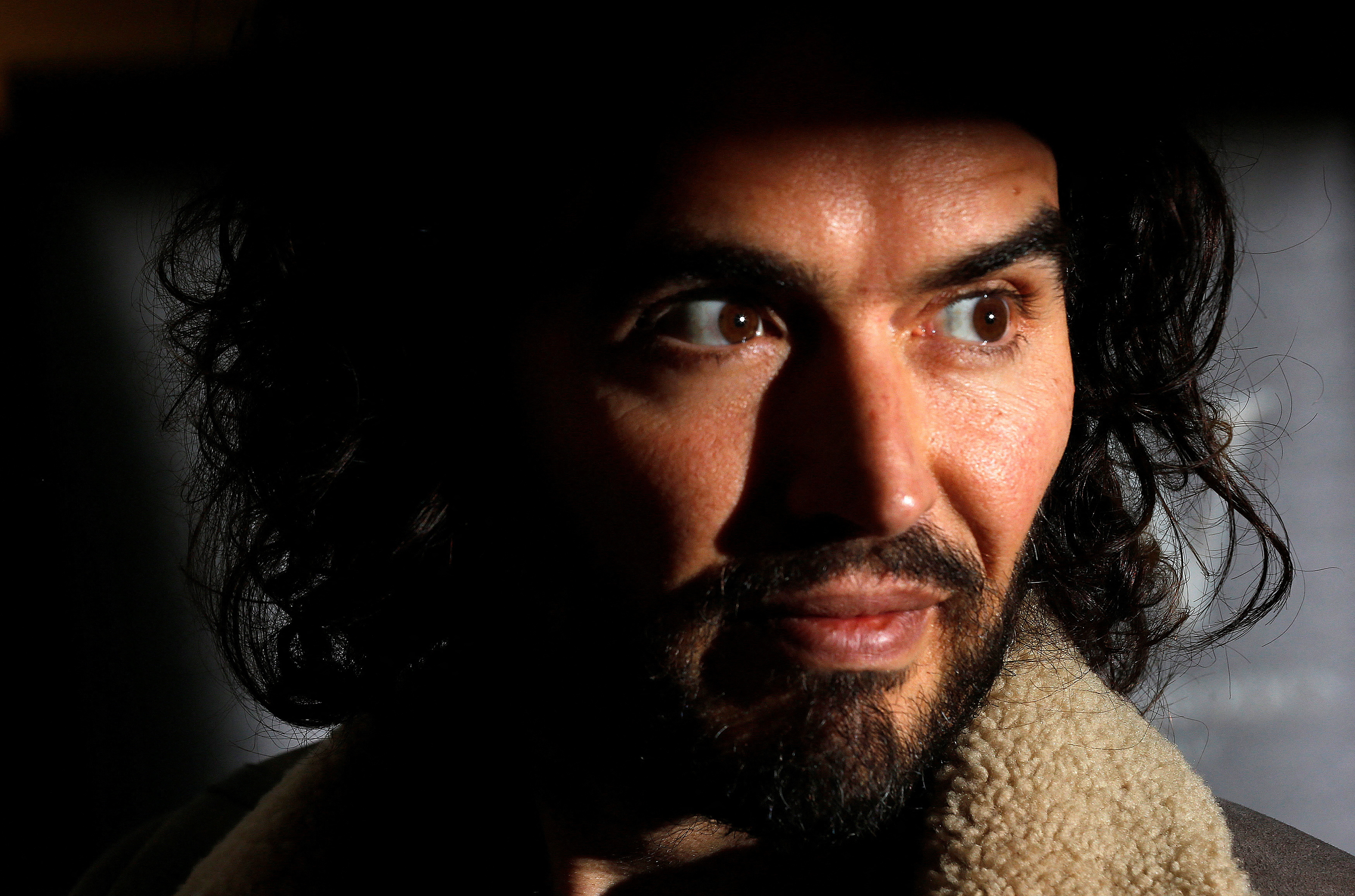 FILE PHOTO: Comedian Russell Brand poses for photographers before signing copies of his new book entitled "Revolution" in central London, December 5, 2014. REUTERS/Suzanne Plunkett (BRITAIN - Tags: ENTERTAINMENT MEDIA)/File Photo