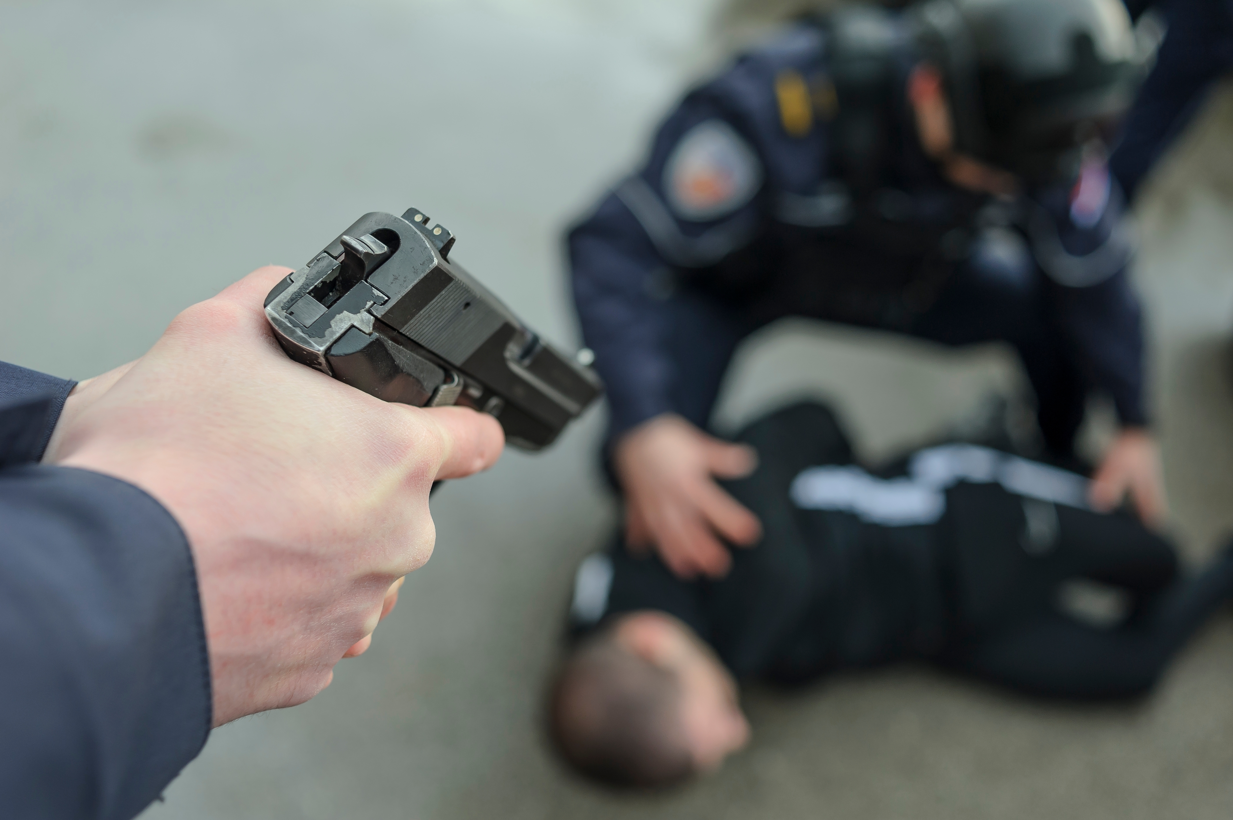 Hapsenje srbija, 
Belgrade, Serbia - March 2021; Serbia Police Academy (KPU) students train in police duties arresting a suspect; policeman pointing a gun at suspect