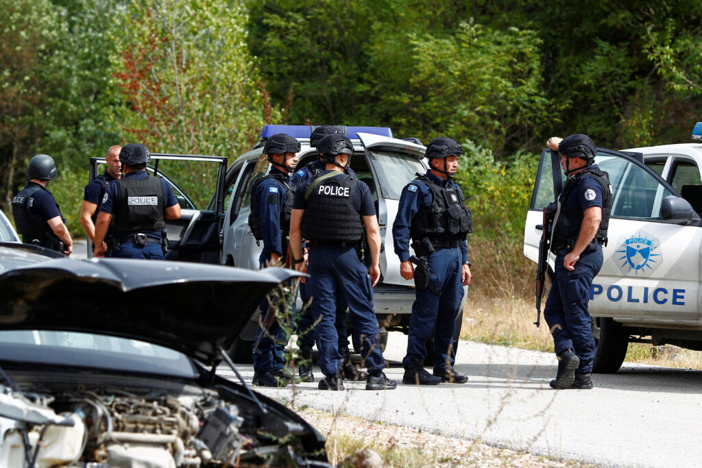 Police officers stand guard in the aftermath of a shooting, near the village of Zvecane, Kosovo September 24, 2023. REUTERS/Ognen Teofilovski