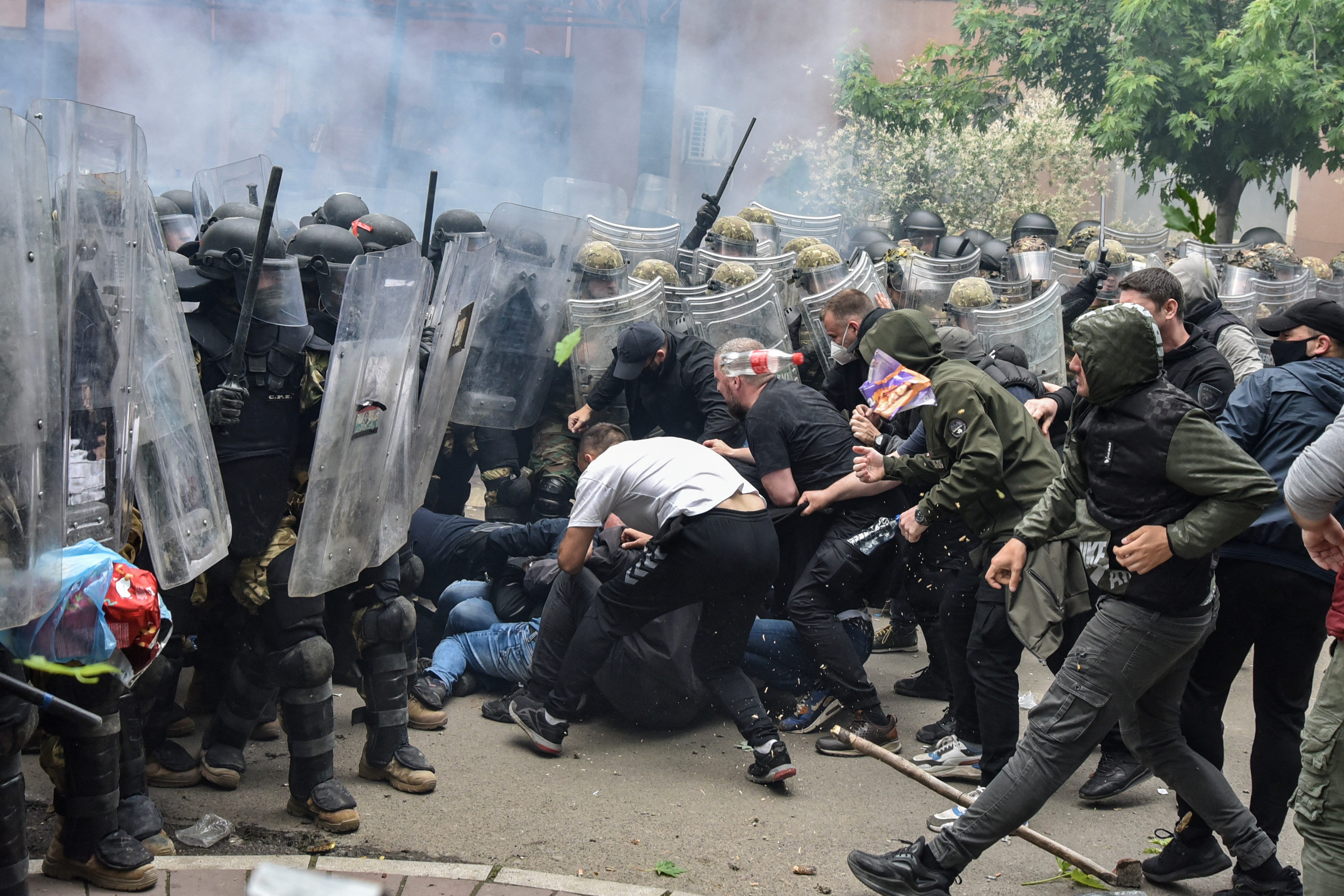 NATO Kosovo Force (KFOR) soldiers clash with local Kosovo Serb protesters at the entrance of the municipality office, in the town of Zvecan, Kosovo, May 29, 2023. REUTERS/Laura Hasani