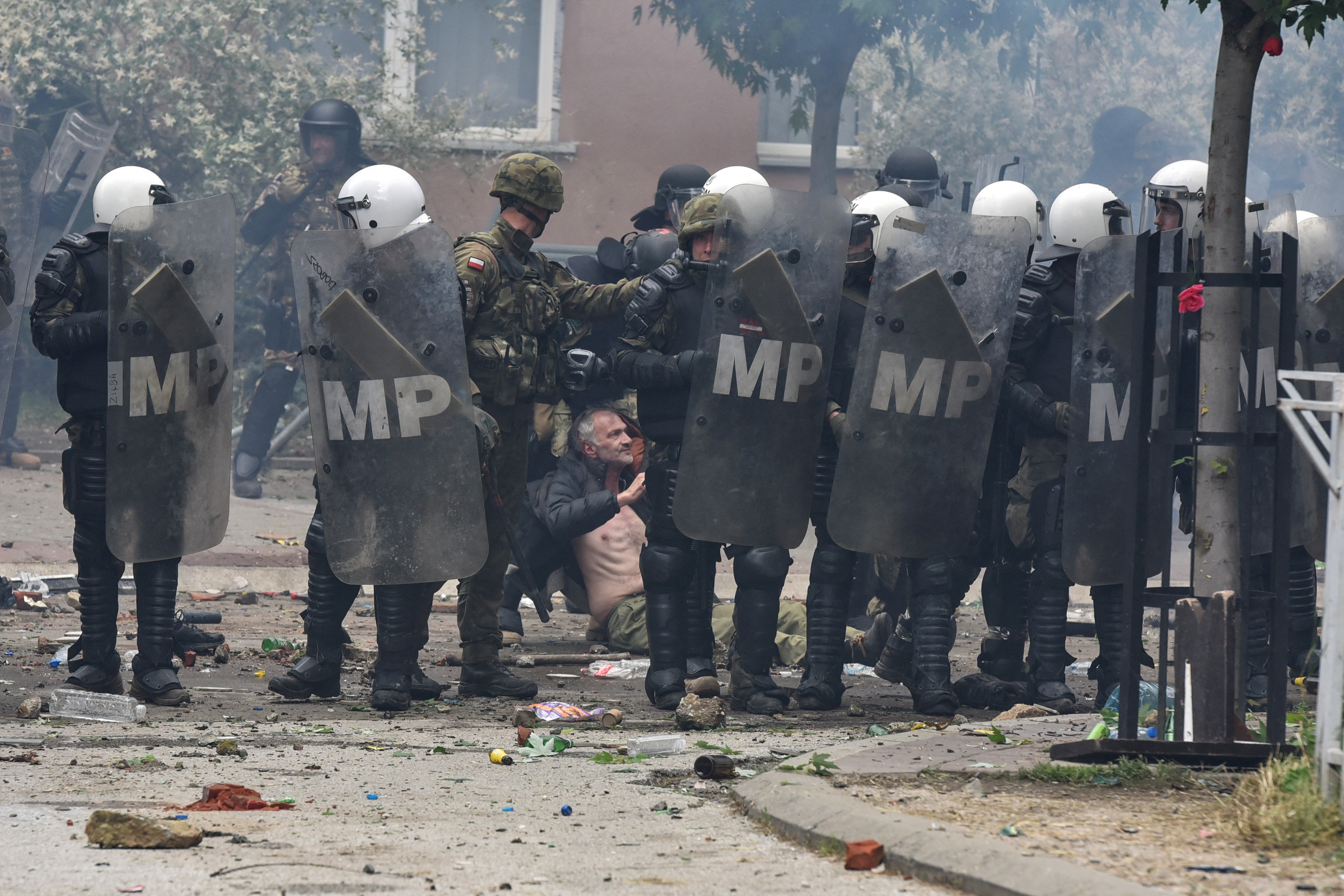 NATO Kosovo Force (KFOR) soldiers detain a local Kosovo Serb protester at the entrance of the municipality office, in the town of Zvecan, Kosovo, May 29, 2023. REUTERS/Laura Hasani