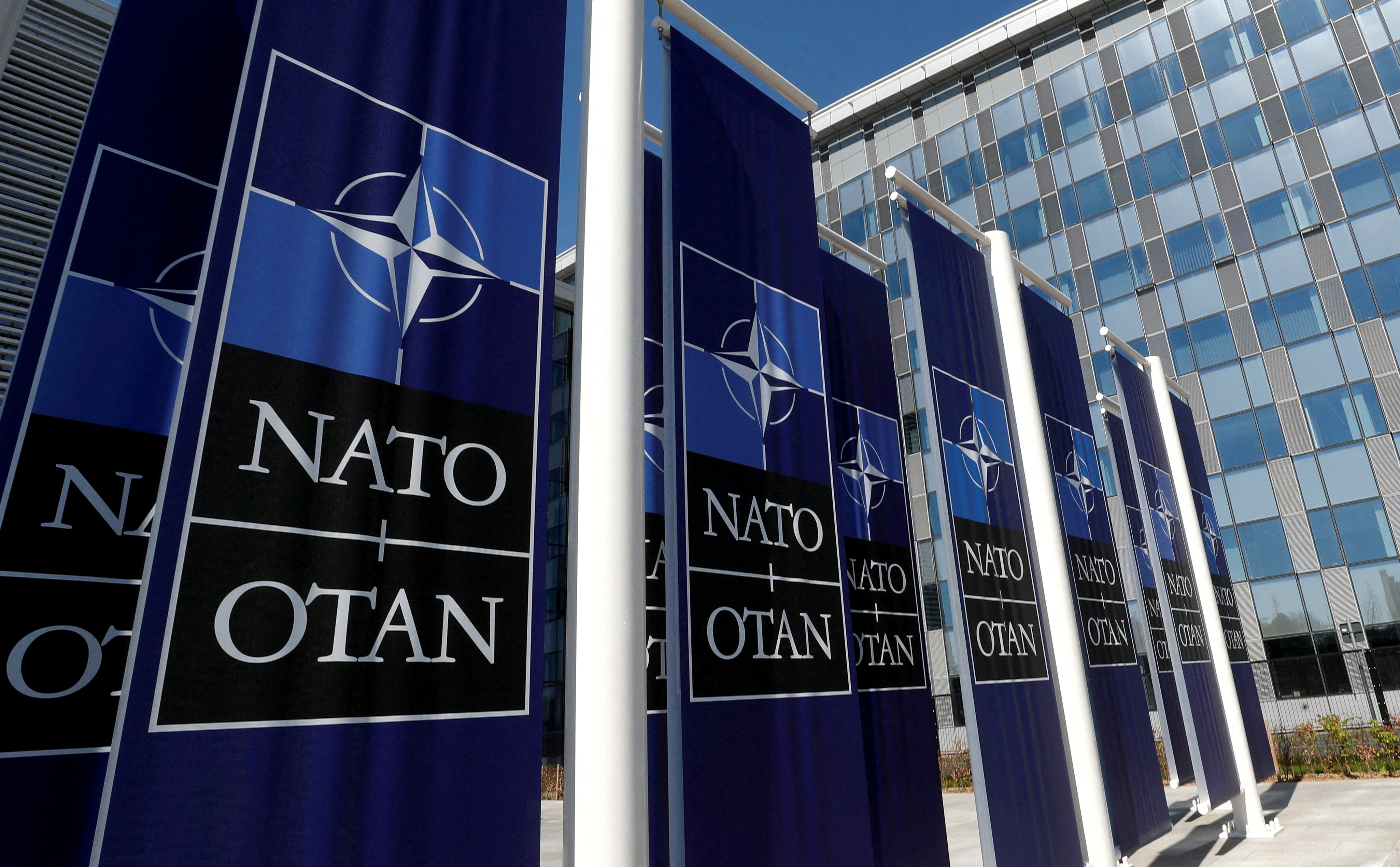 FILE PHOTO: Banners displaying the NATO logo are placed at the entrance of new NATO headquarters during the move to the new building, in Brussels, Belgium April 19, 2018.  REUTERS/Yves Herman//File Photo
