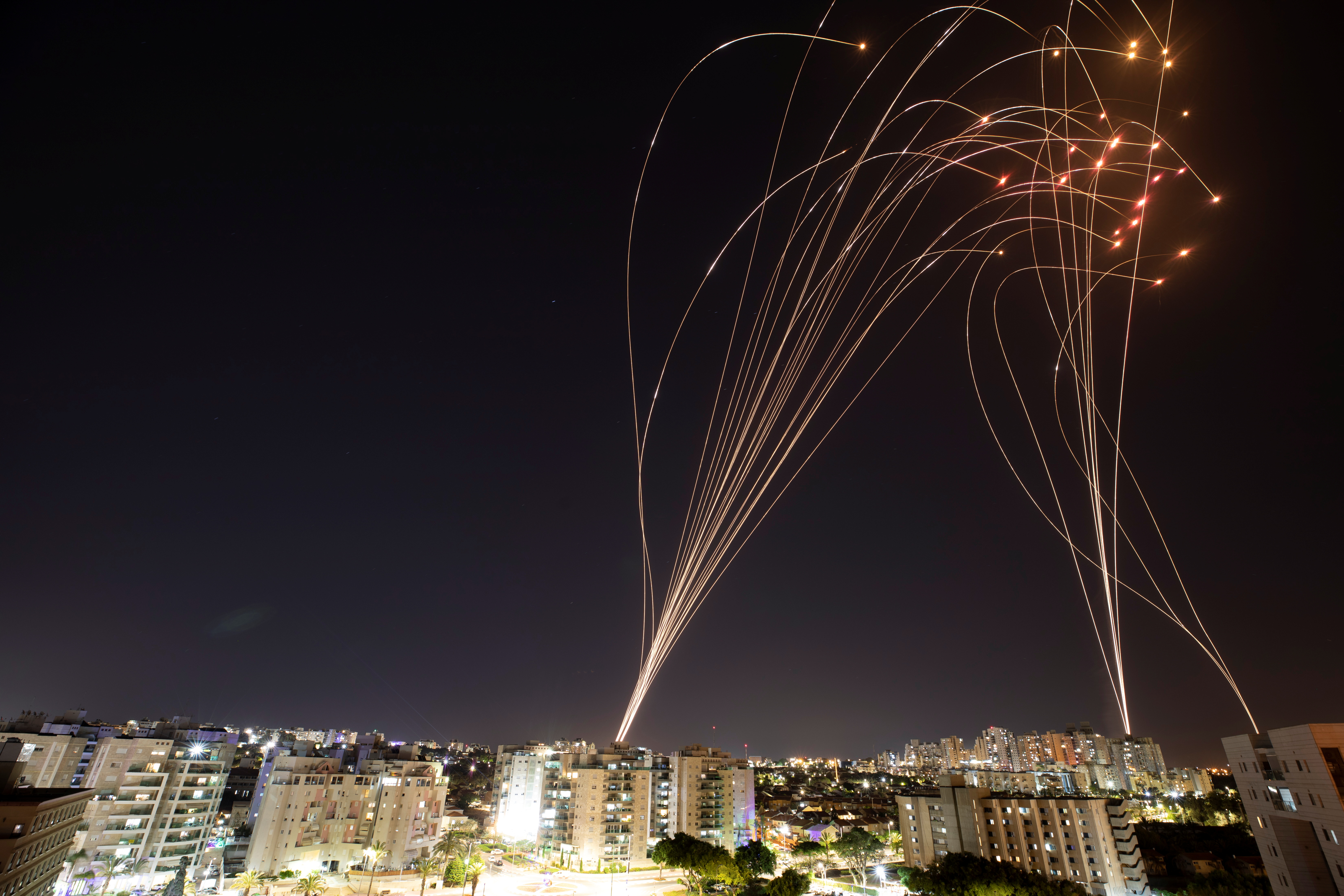 Streaks of light are seen as Israel's Iron Dome anti-missile system intercepts rockets launched from the Gaza Strip towards Israel, as seen from Ashkelon, Israel, May 11, 2021.. REUTERS/Nir Elias