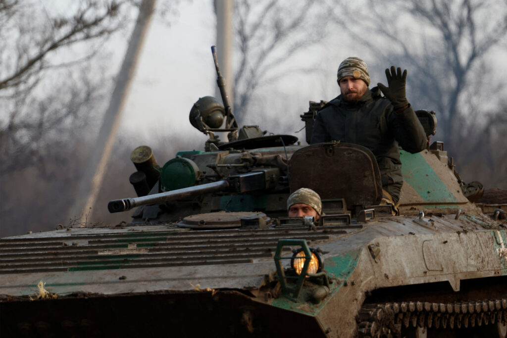 A Ukrainian serviceman waves from a tank, as Russia's attack on Ukraine continues, during intense shelling on Christmas Day at the frontline in Bakhmut, Ukraine, December 25, 2022. REUTERS/Clodagh Kilcoyne