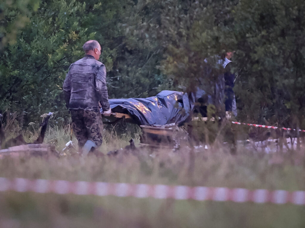 Emergency specialists carry a body bag near wreckages of the private jet linked to Wagner mercenary chief Yevgeny Prigozhin at the crash site in the Tver region, Russia, August 24, 2023. REUTERS/Marina Lystseva     TPX IMAGES OF THE DAY