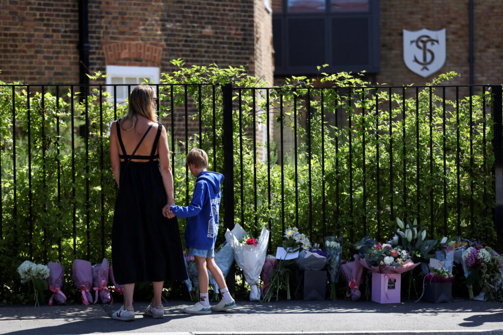People lay floral tributes after an eight-year-old girl died after a car crashed into The Study Preparatory School in Wimbledon, London, Britain, July 7, 2023, REUTERS/Hollie Adams     TPX IMAGES OF THE DAY