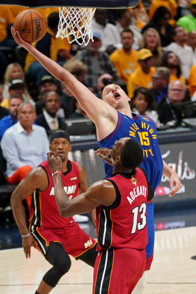 Jun 1, 2023; Denver, CO, USA; Denver Nuggets center Nikola Jokic (15) reaches for the ball against Miami Heat center Bam Adebayo (13) during the second half in game one of the 2023 NBA Finals at Ball Arena. Mandatory Credit: Kyle Terada-USA TODAY Sports
