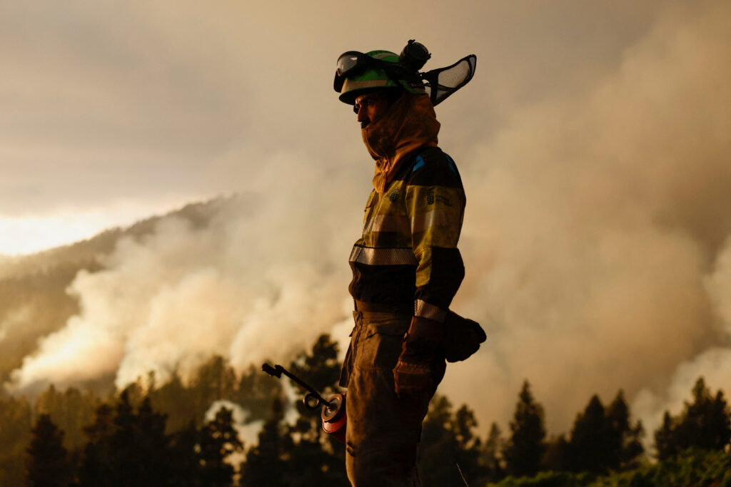 A forest firefighter from the EIRIF works during the extinction of the Tijarafe fire on the Canary Island of La Palma, Spain July 16, 2023 REUTERS/Borja Suarez