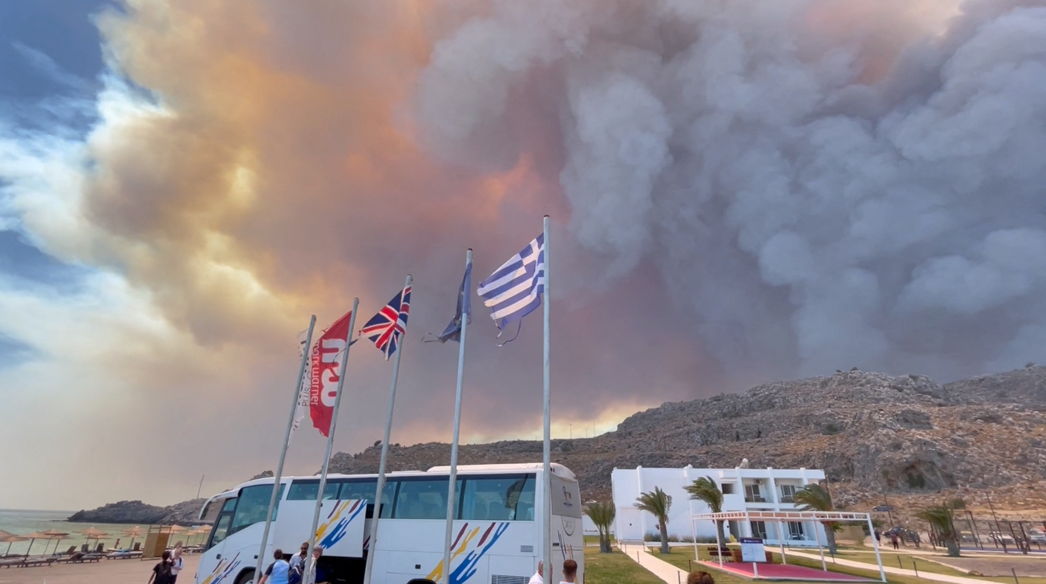 Smoke rises from a wildfire in Rhodes Island, Greece, July 22, 2023 in this screengrab taken from a social media video. Tiktok/@blairsbrainiacs/via REUTERS  THIS IMAGE HAS BEEN SUPPLIED BY A THIRD PARTY. MANDATORY CREDIT. NO RESALES. NO ARCHIVES.