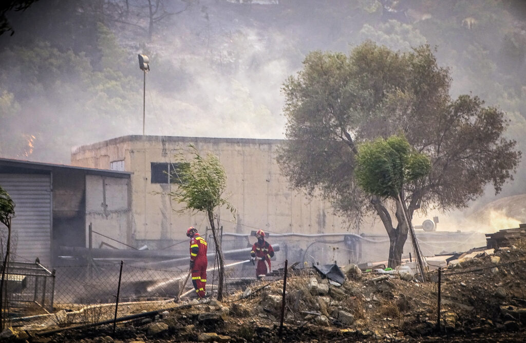 Firefighters operate near a wildfire on the island of Rhodes, Greece, July 22, 2023. Argiris Mantikos/Eurokinissi via REUTERS ATTENTION EDITORS - THIS IMAGE HAS BEEN SUPPLIED BY A THIRD PARTY. NO RESALES. NO ARCHIVES. NO EDITORIAL SALES IN GREECE