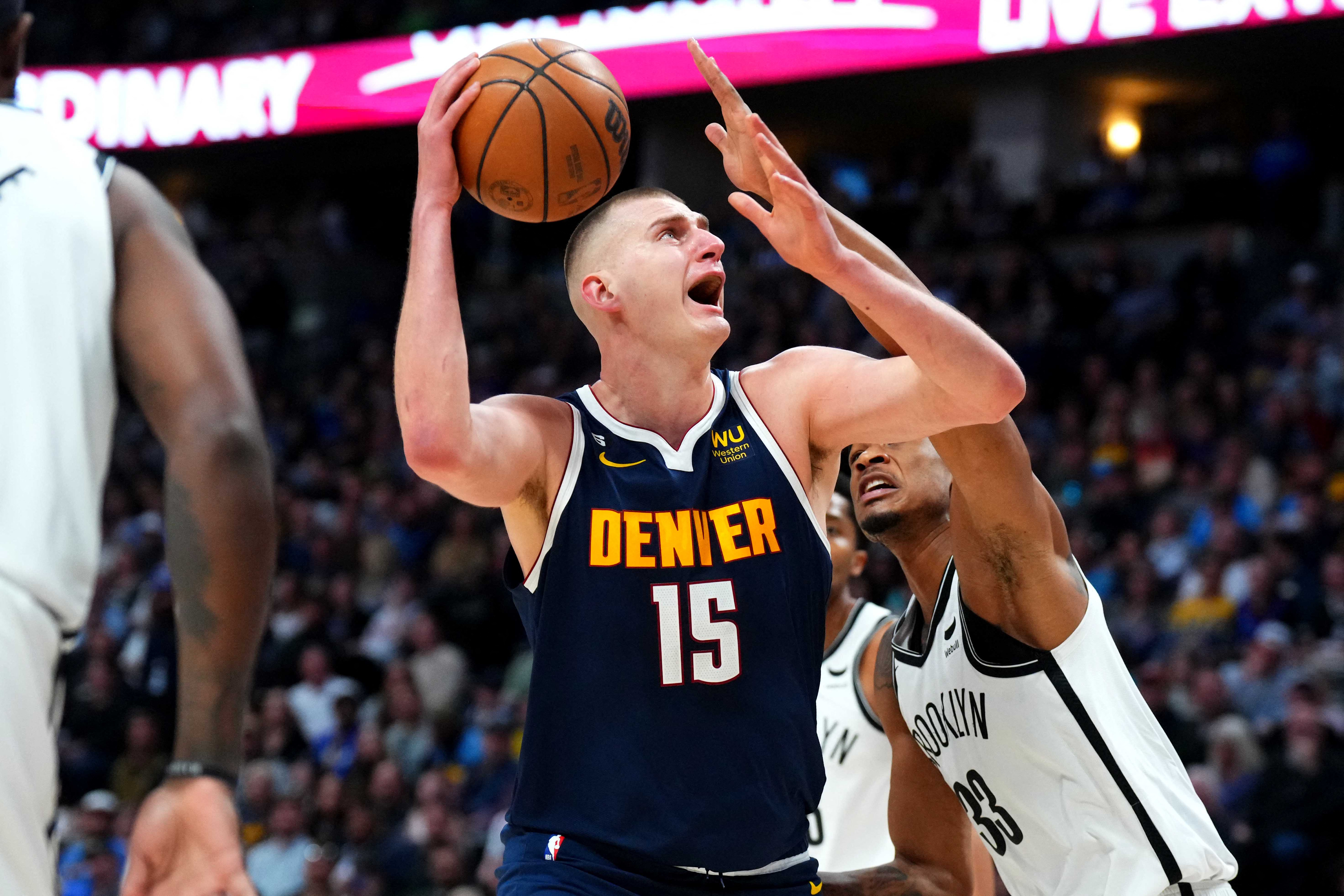 Mar 12, 2023; Denver, Colorado, USA; Brooklyn Nets center Nic Claxton (33) guards on Denver Nuggets center Nikola Jokic (15) in the first quarter at Ball Arena. Mandatory Credit: Ron Chenoy-USA TODAY Sports