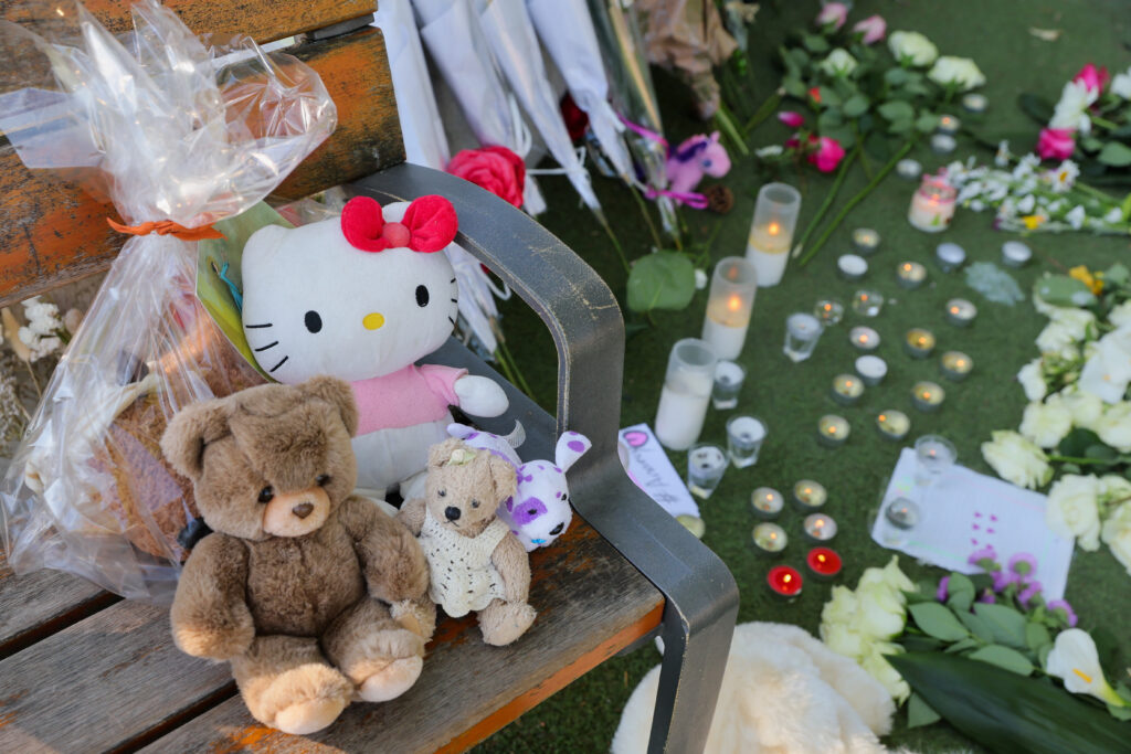 A general view of flowers, candles and toys left at the Le Paquier park after several children and adults were injured in a knife attack, near the lake in Annecy, in the French Alps, France, June 9, 2023. REUTERS/Denis Balibouse