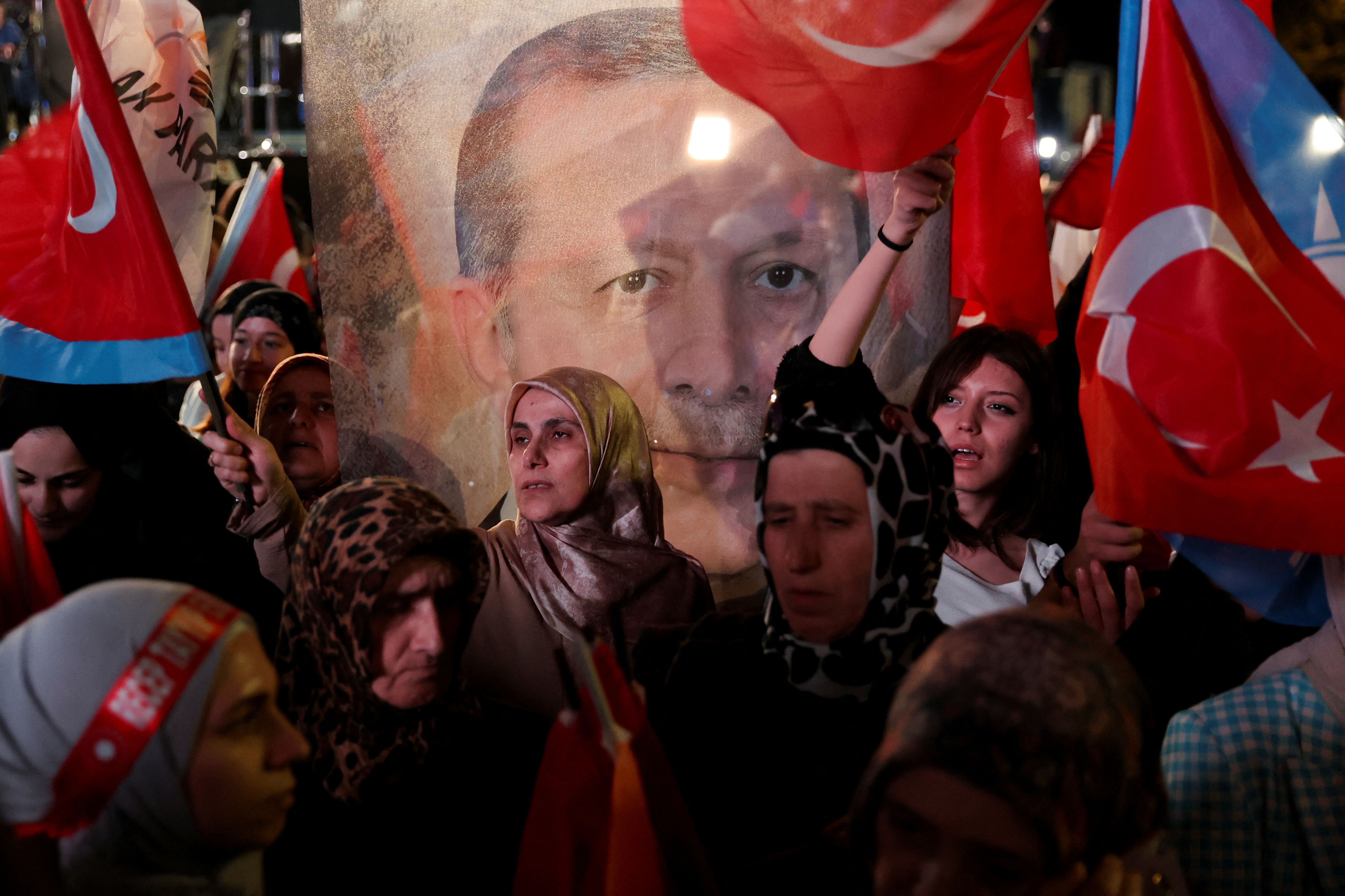 Supporters of Turkish President Recep Tayyip Erdogan and AK Party (AKP) wave flags at the AK Party headquarters in Ankara, Turkey May 14, 2023. REUTERS/Umit Bektas