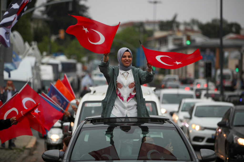 A woman waves Turkish flags on the day of the second round of the presidential election in Istanbul, Turkey May 28, 2023. REUTERS/Kemal Aslan