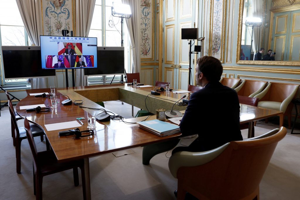 French President Emmanuel Macron attends a video-conference with German Chancellor Olaf Scholz and Chinese President Xi Jinping to discuss the Ukraine crisis at the Elysee Palace in Paris, France, March 8, 2022. REUTERS/Benoit Tessier/Pool