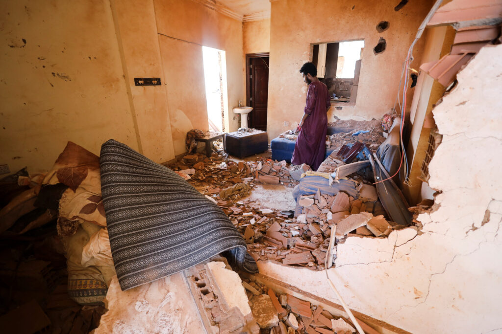 A man looks at belongings inside a damaged house during clashes between the paramilitary Rapid Support Forces and the army in Khartoum, Sudan April 17, 2023. REUTERS/Stringer  NO RESALES. NO ARCHIVES