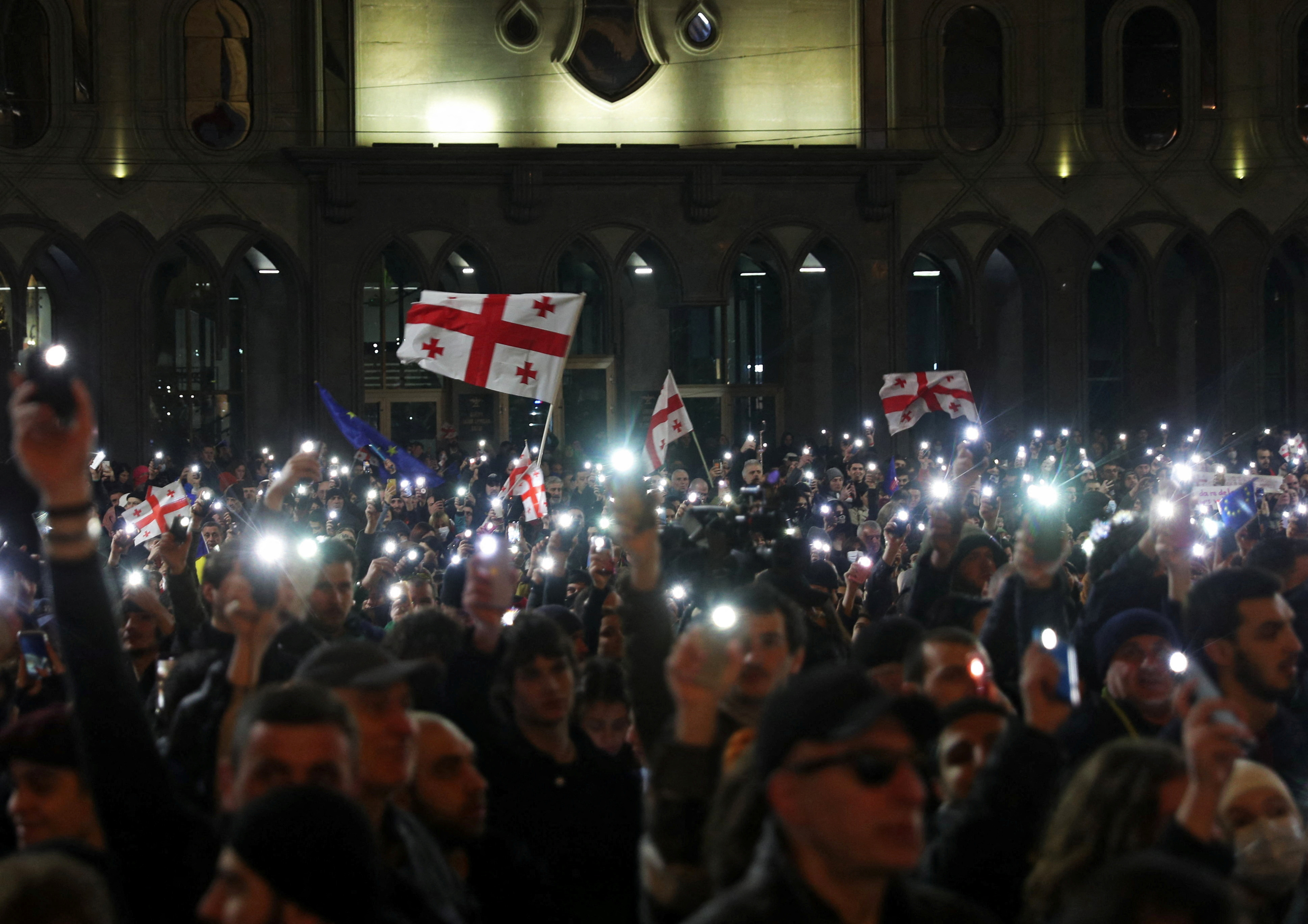 People take part in a protest demanding the government formally denounce the "foreign agents" bill, outside the parliament building in Tbilisi, Georgia March 9, 2023. REUTERS/Irakli Gedenidze