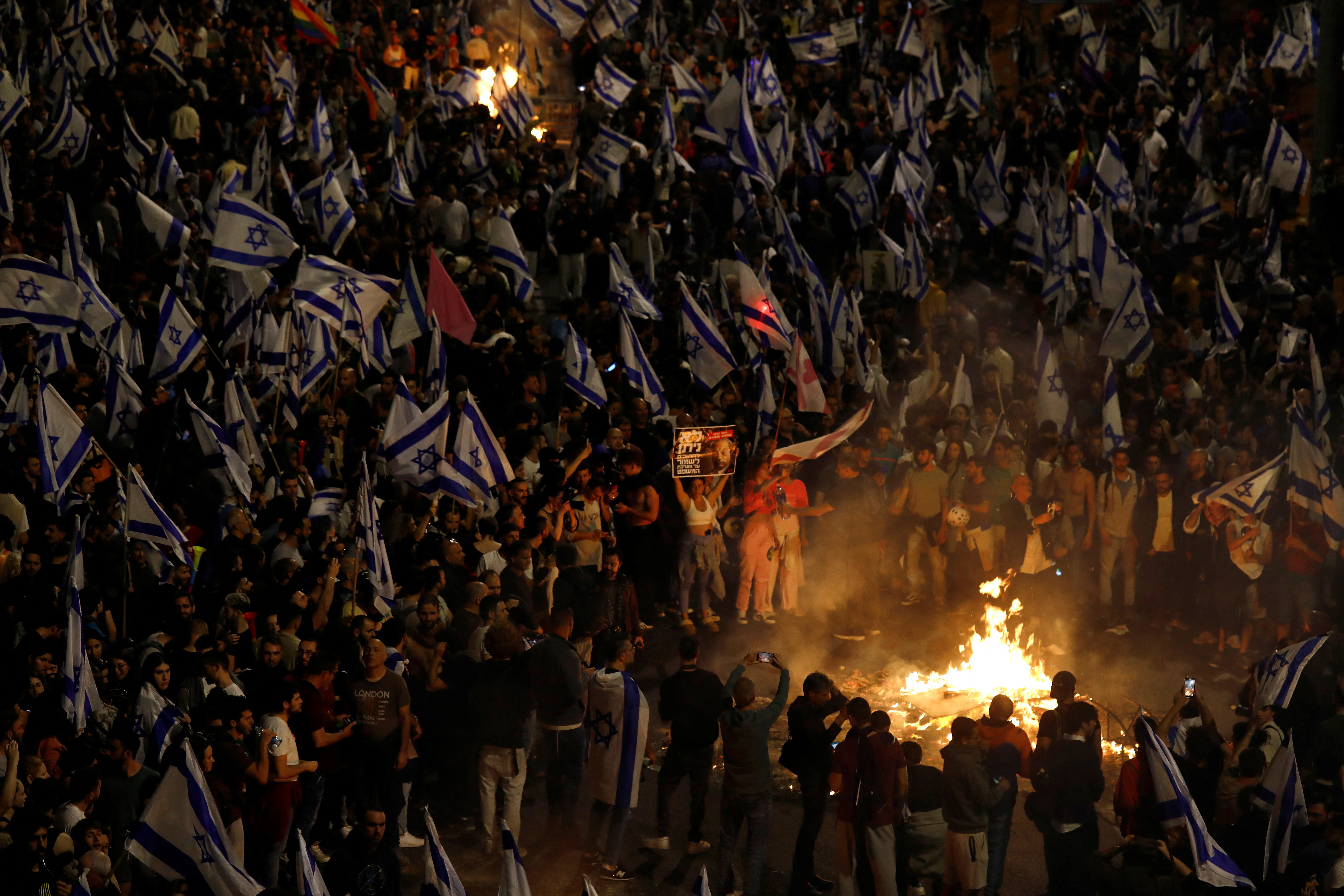 People attend a demonstration after Israeli Prime Minister Benjamin Netanyahu dismissed the defense minister and his nationalist coalition government presses on with its judicial overhaul, in Tel Aviv, Israel, March 26, 2023. REUTERS/Nir Elias