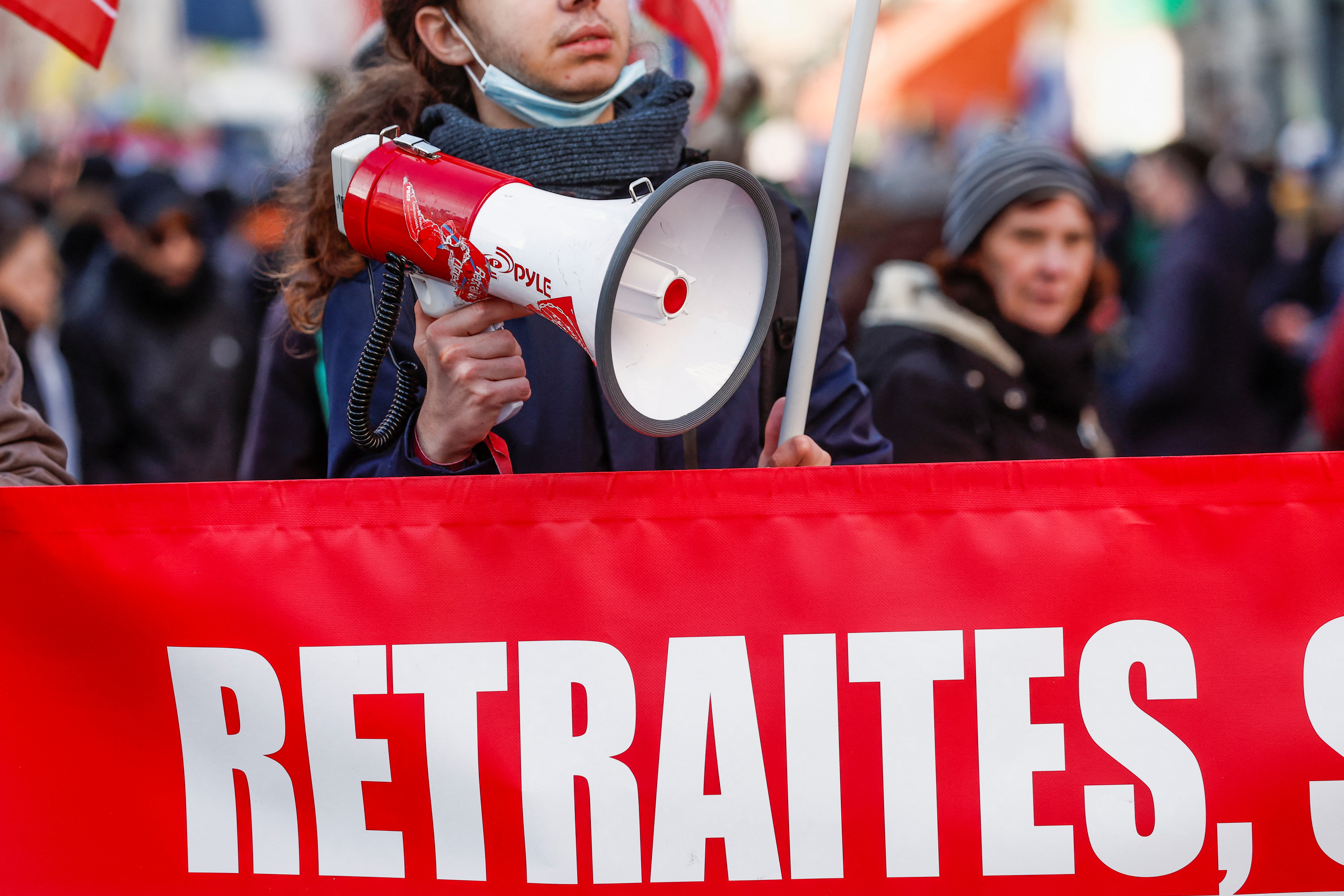 A demonstrator holds a speaker during a rally, called by left-wing La France Insoumise (LFI) party and Youth organizations, against the French government's pension reform plan in Paris, France, January 21, 2023. REUTERS/Benoit Tessier