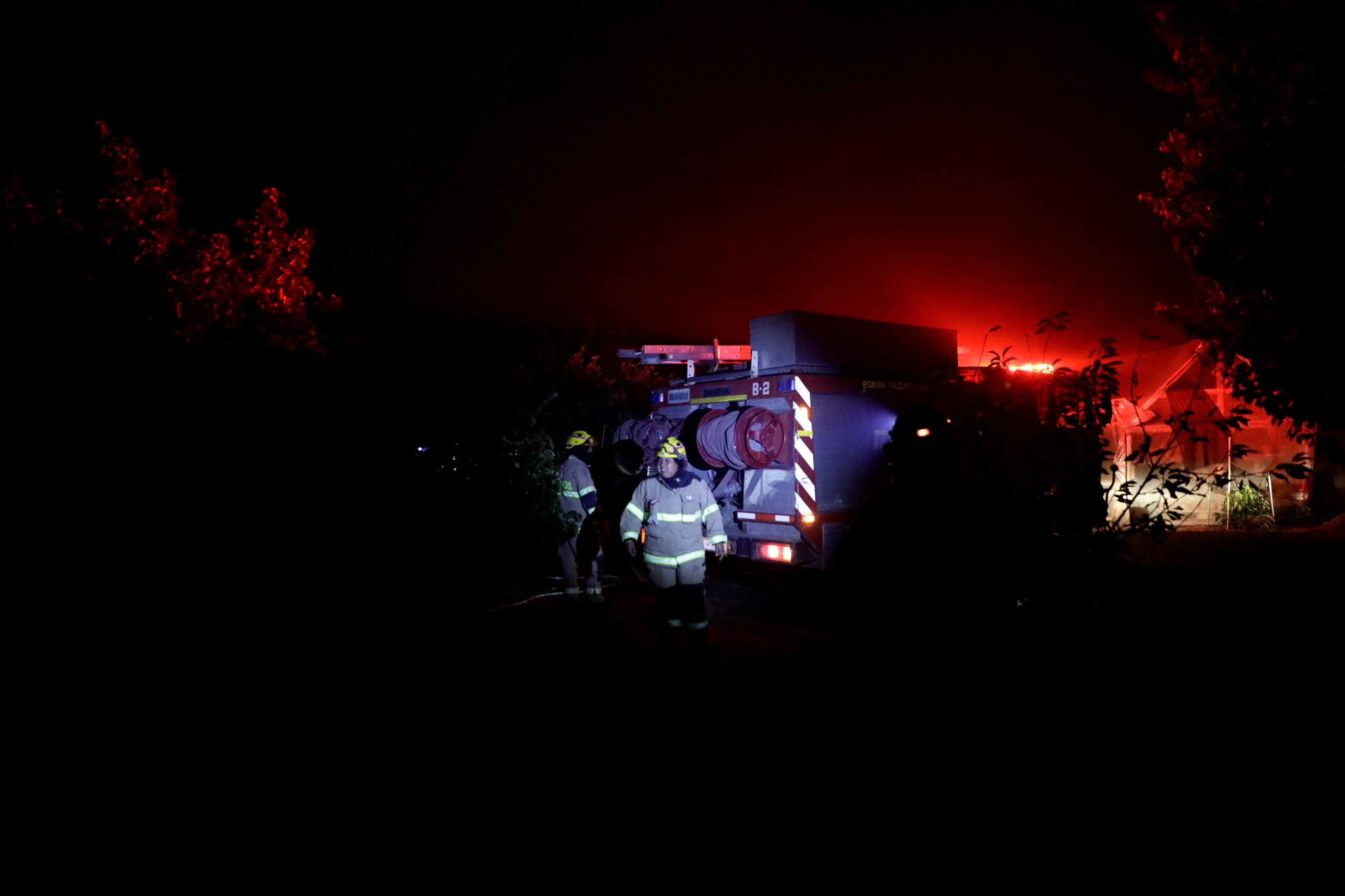 Firefighters work, as a wildfire burns parts of rural areas in Quillon, Chile, February 2, 2023 REUTERS/Juan Gonzalez