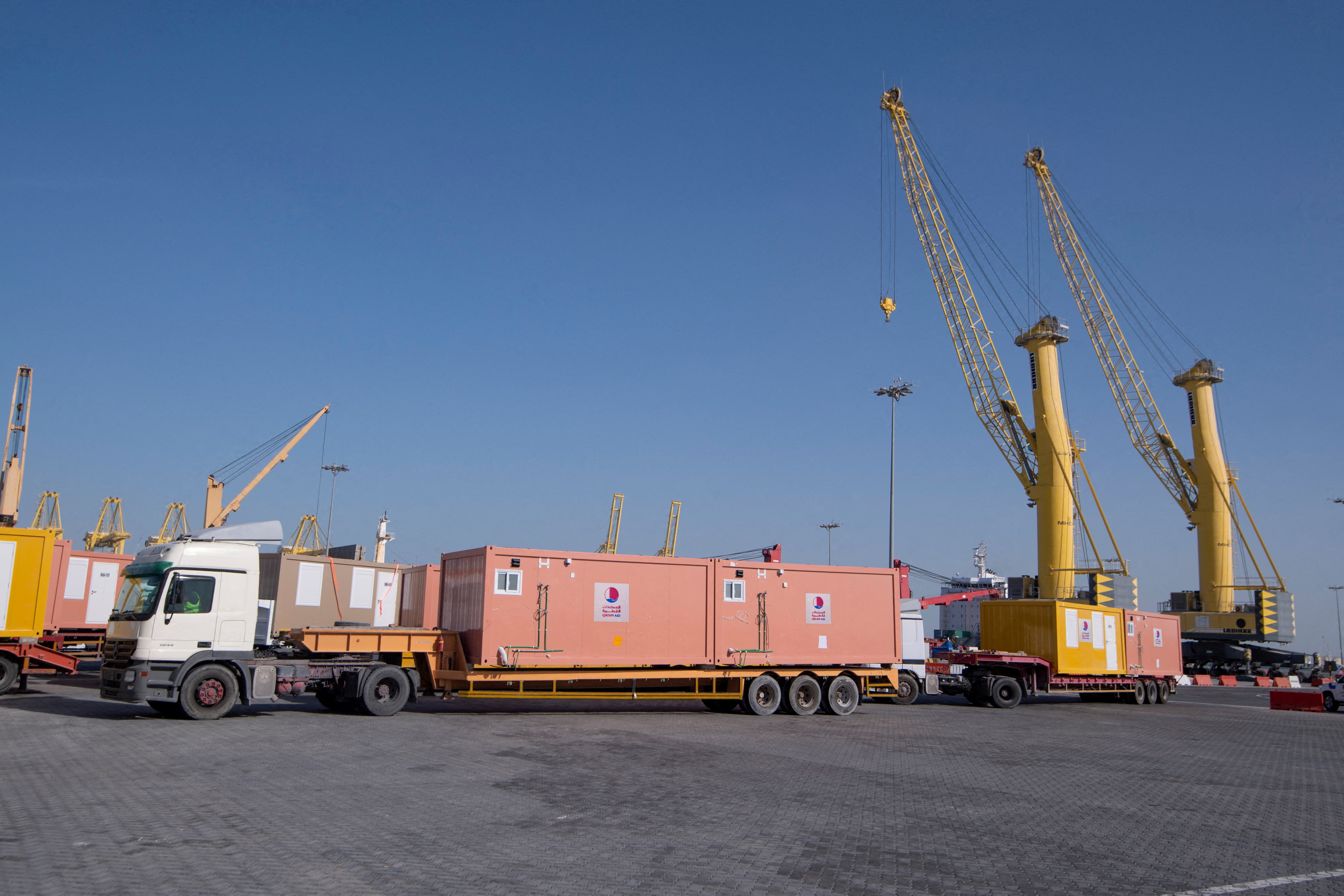 Mobile home cabins to be sent by Qatar to Turkey after deadly earthquake are transported in Hamad Port